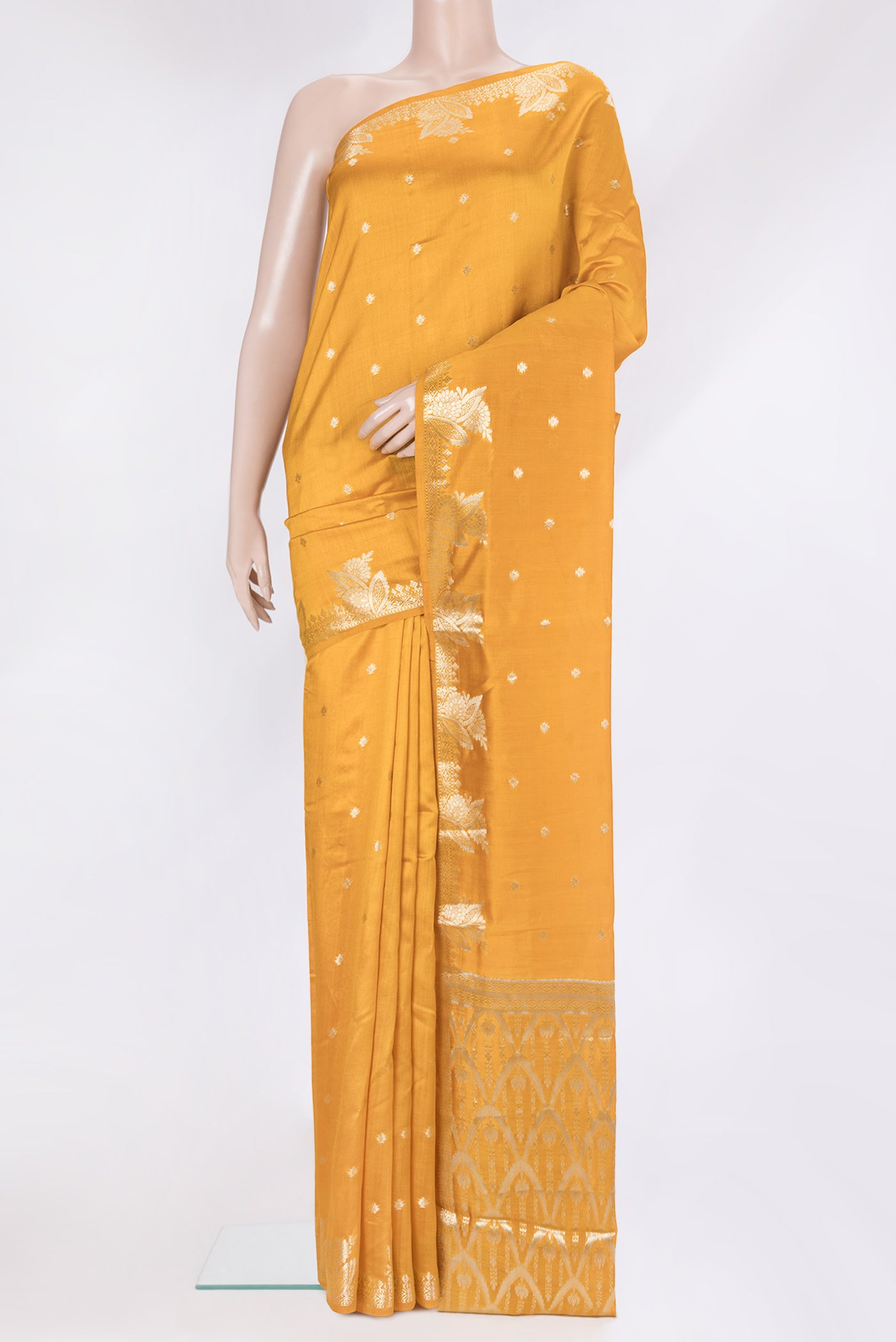 Mustard Tussar Silk Saree with Zari Butta on the body and Fancy Border.  displayed on a mannequin