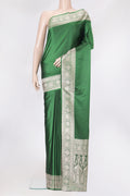 Bottle Green Blended Banarasi Silk Saree with Plain Body and Zari Border.  displayed on a mannequin