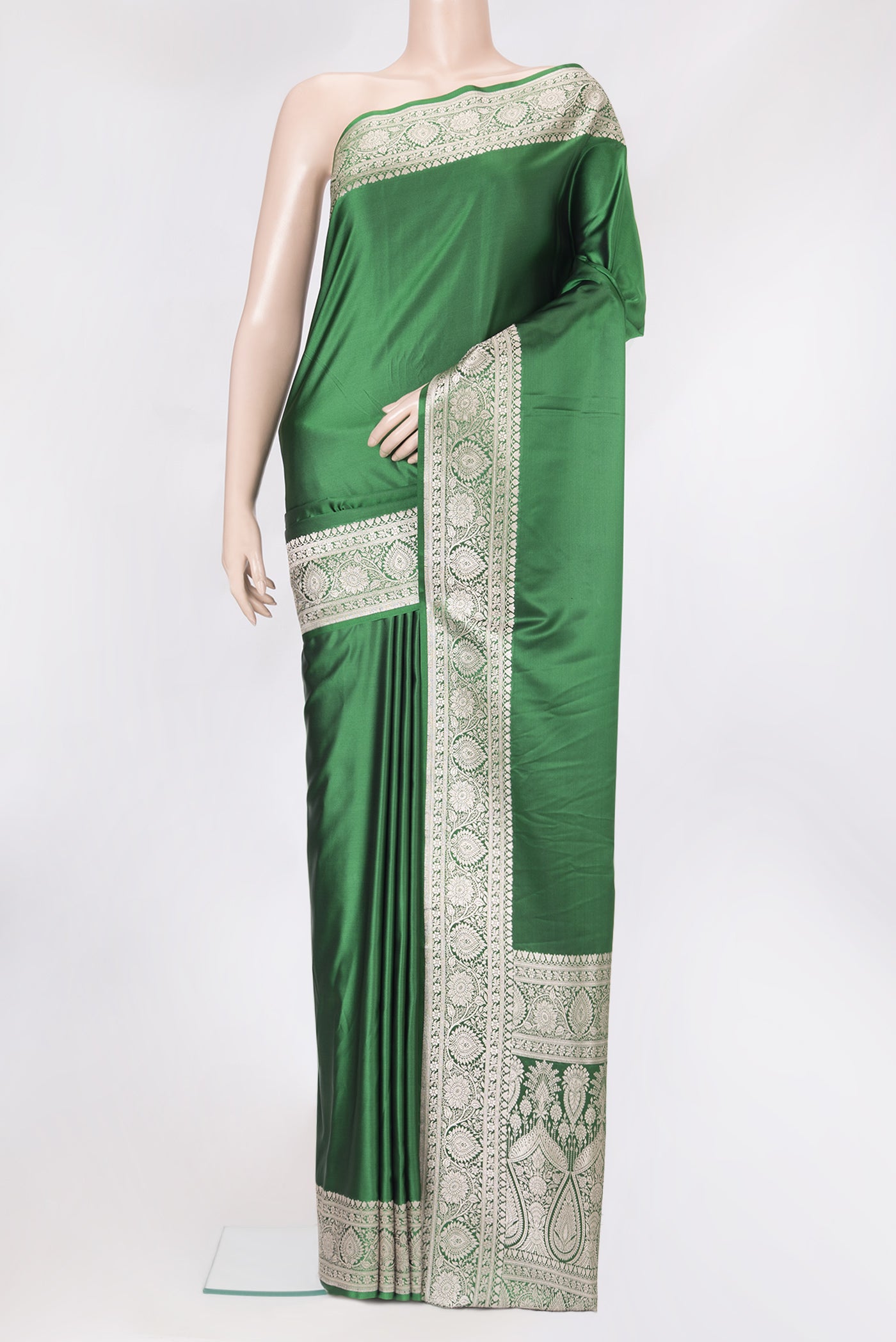 Bottle Green Blended Banarasi Silk Saree with Plain Body and Zari Border.  displayed on a mannequin