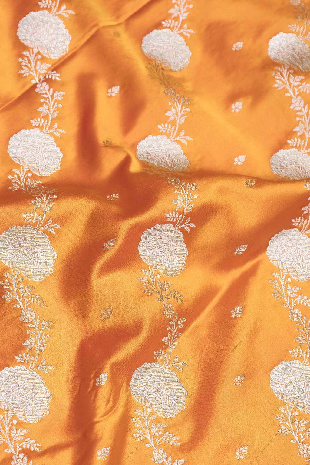 Close up of Yellow Dual Tone Blended Banarasi Saree with Zari Brocade on the body and Zari Border.  displaying folds
