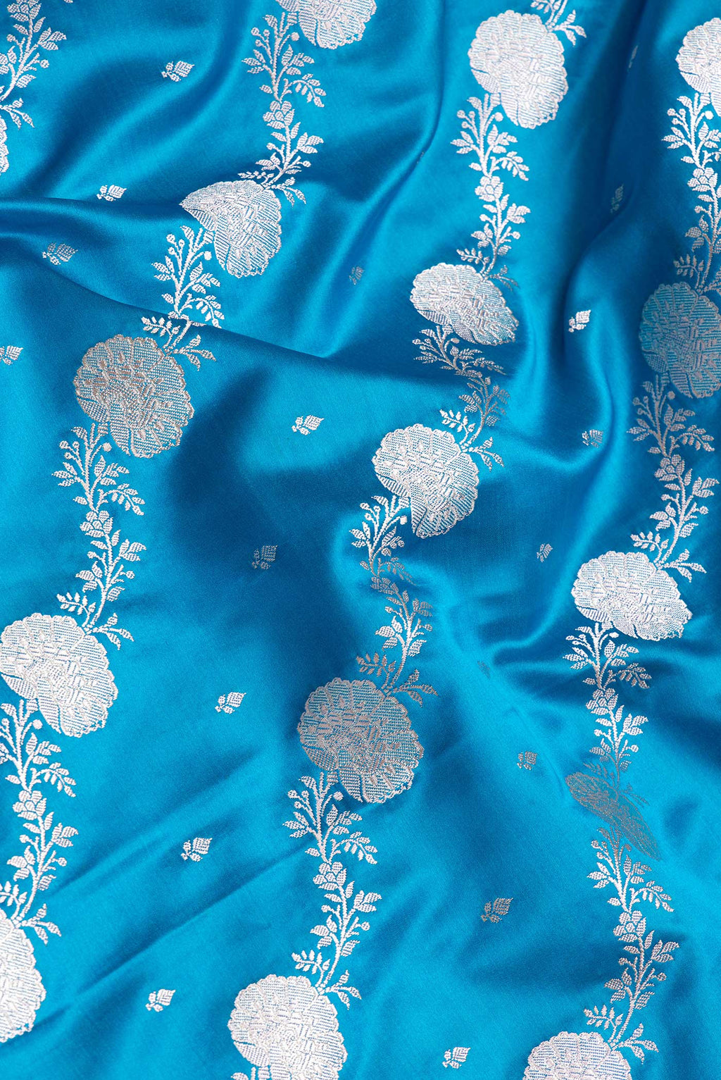 Close up of Sky Blue Dual Tone Blended Banarasi Silk Saree with Zari Brocade on the body and Zari Border.  displaying folds