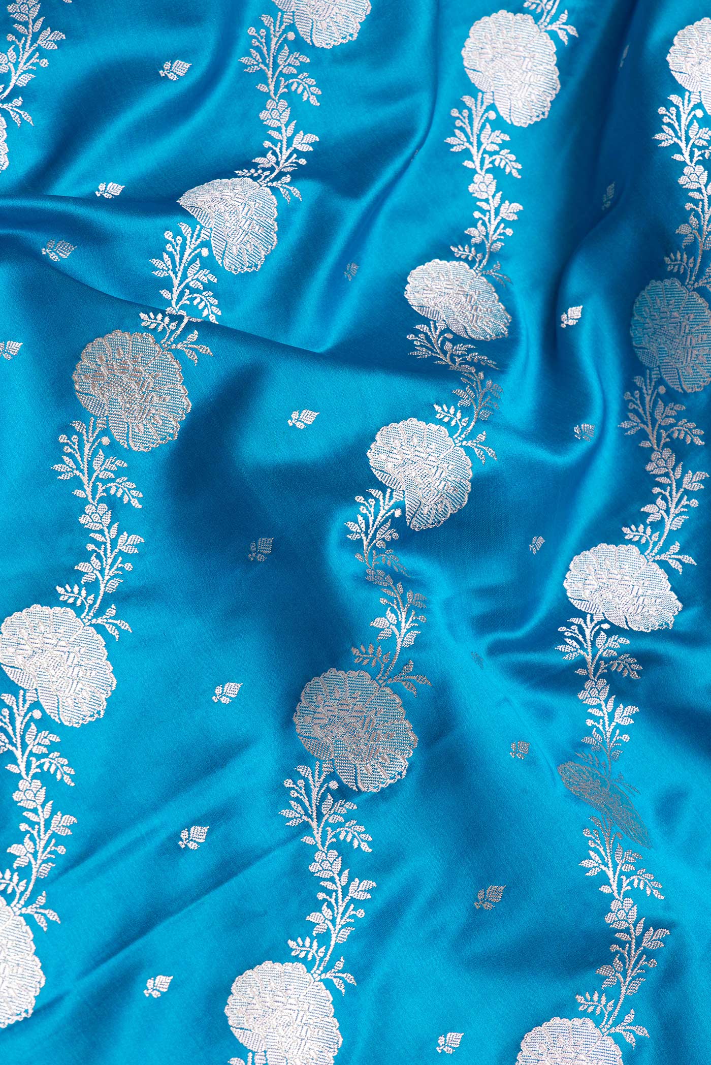 Close up of Sky Blue Dual Tone Blended Banarasi Silk Saree with Zari Brocade on the body and Zari Border.  displaying folds