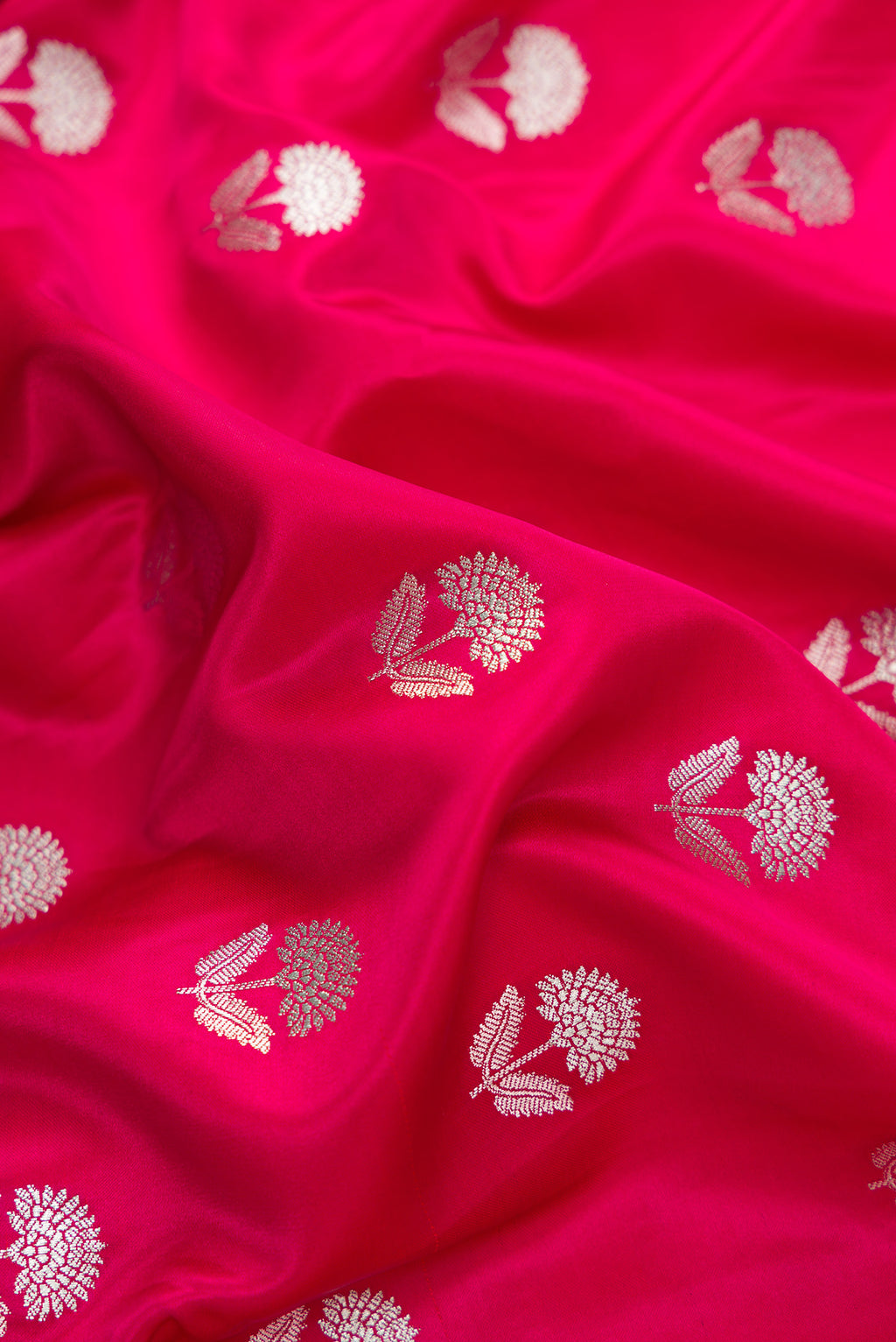Close up of Dark Pink Dual Tone Blended Banarasi Silk Saree with Zari Butta on the body and Zari Border.  displaying folds