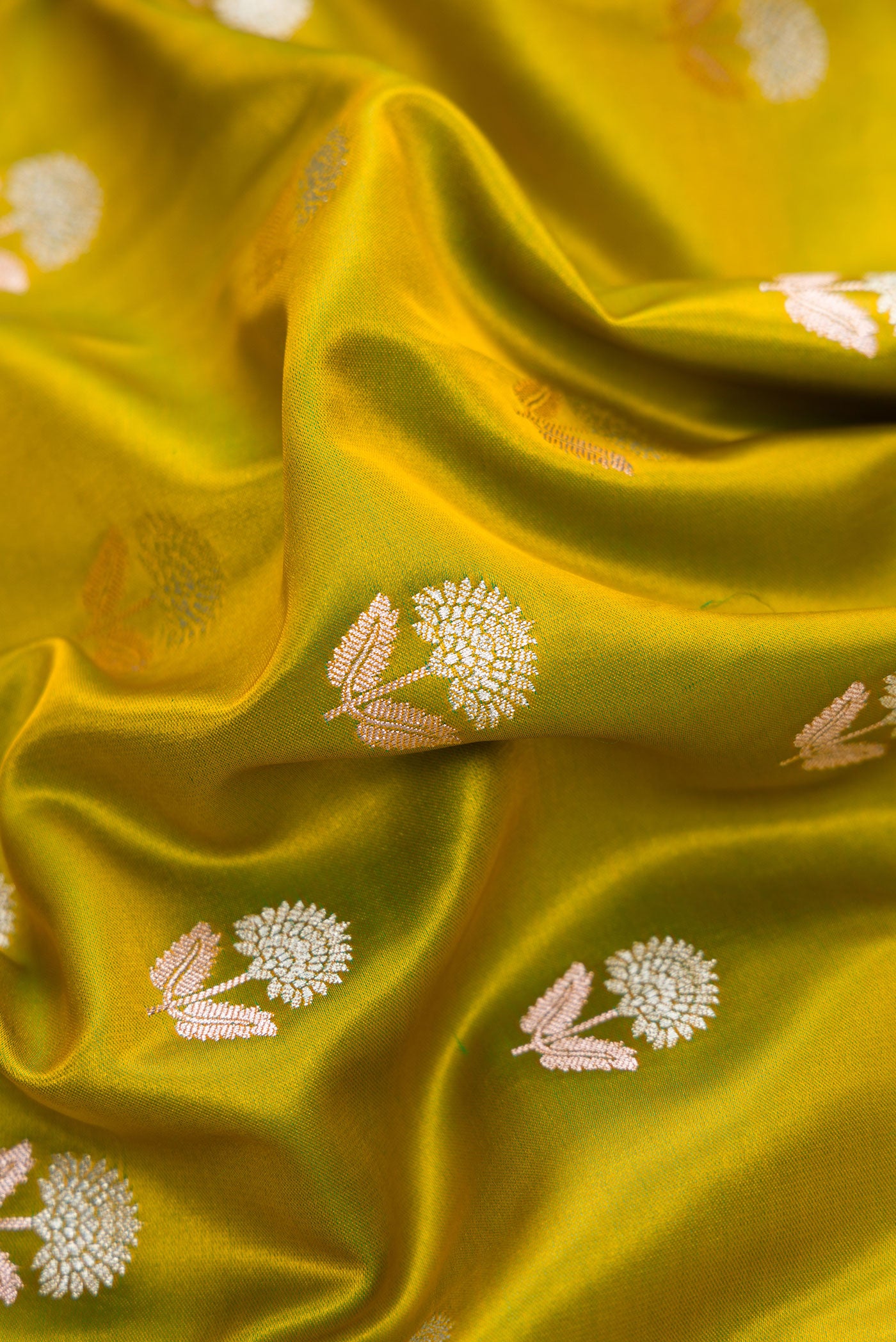Close up of Mehandi Green Dual Tone Blended Banarasi Silk Saree with Zari Butta on the body and Zari Border.  displaying folds