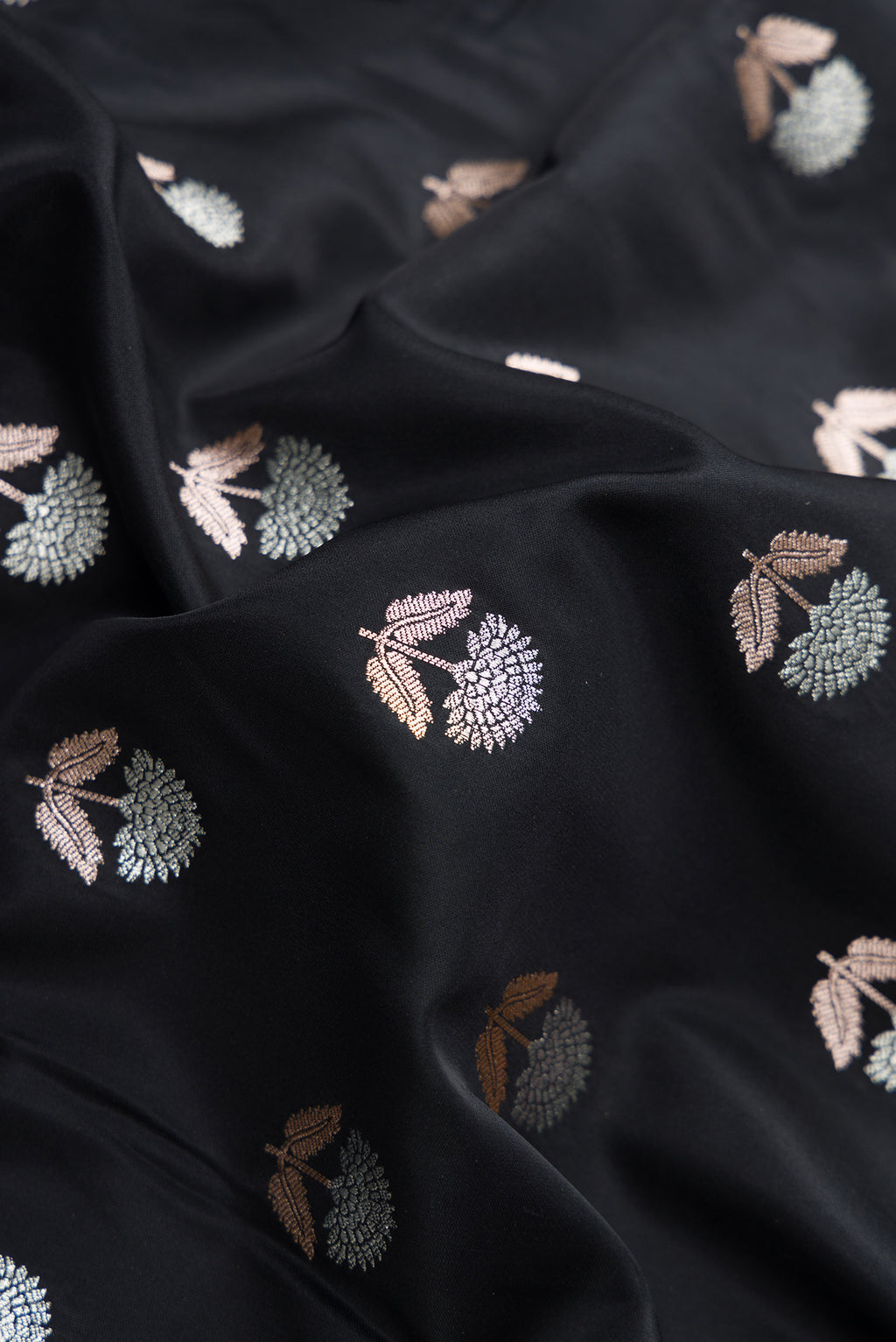 Close up of Black Dual Tone Blended Banarasi Silk Saree with Zari Butta on the body and Zari Border.  displaying folds