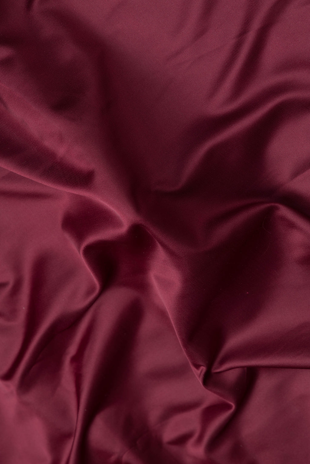 Close up of Maroon Dual Tone Blended Banarasi Silk Saree with Plain Body and Zari Border.  displaying folds