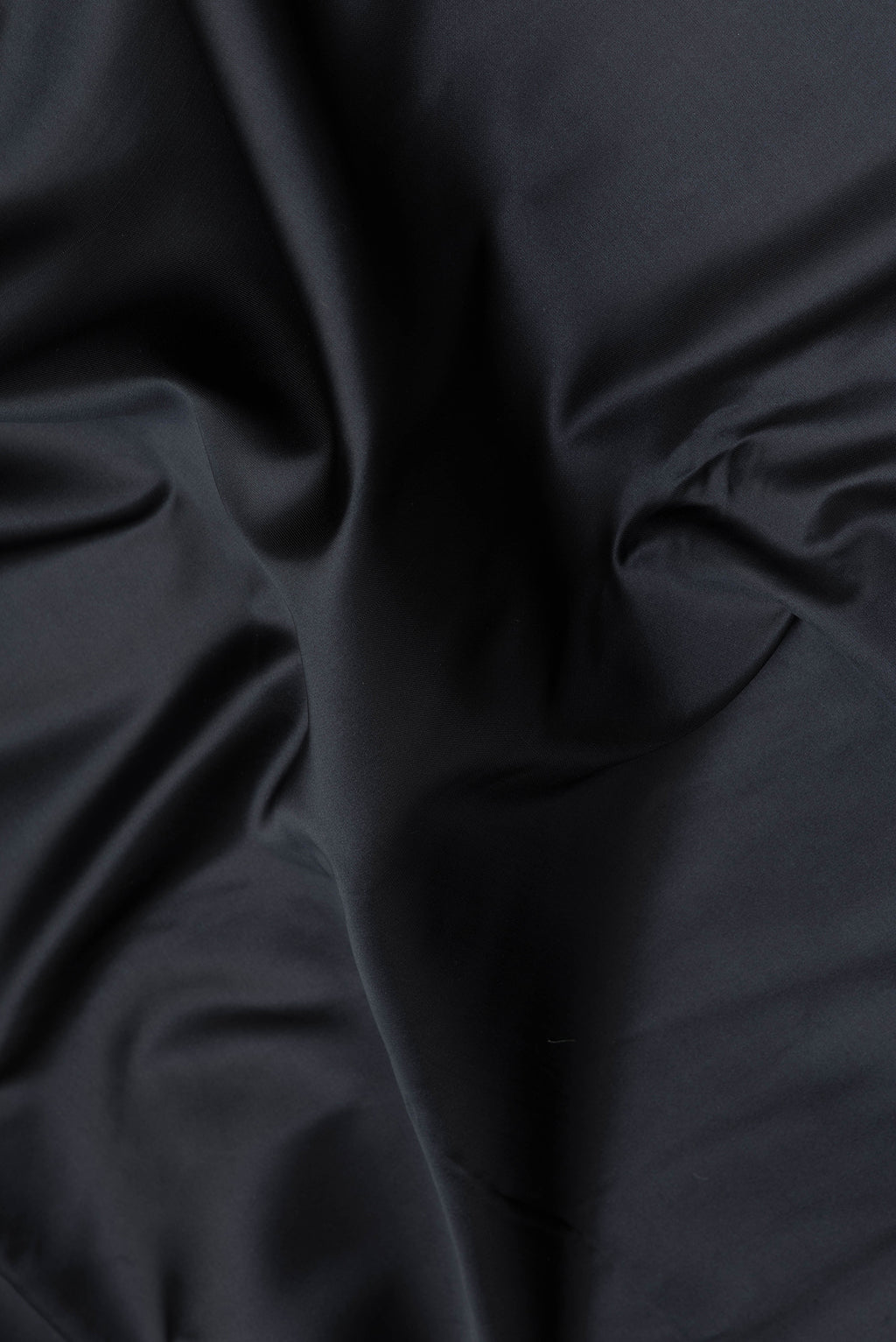 Close up of Black Blended Banarasi Silk Saree with Plain Body and Zari Border.  displaying folds
