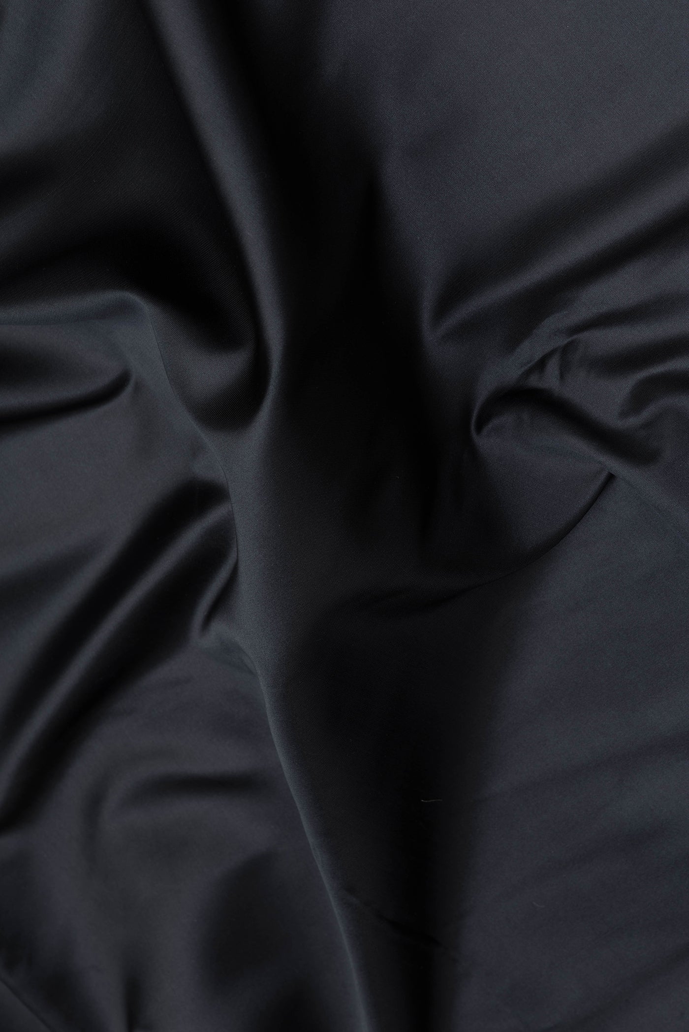 Close up of Black Blended Banarasi Silk Saree with Plain Body and Zari Border.  displaying folds