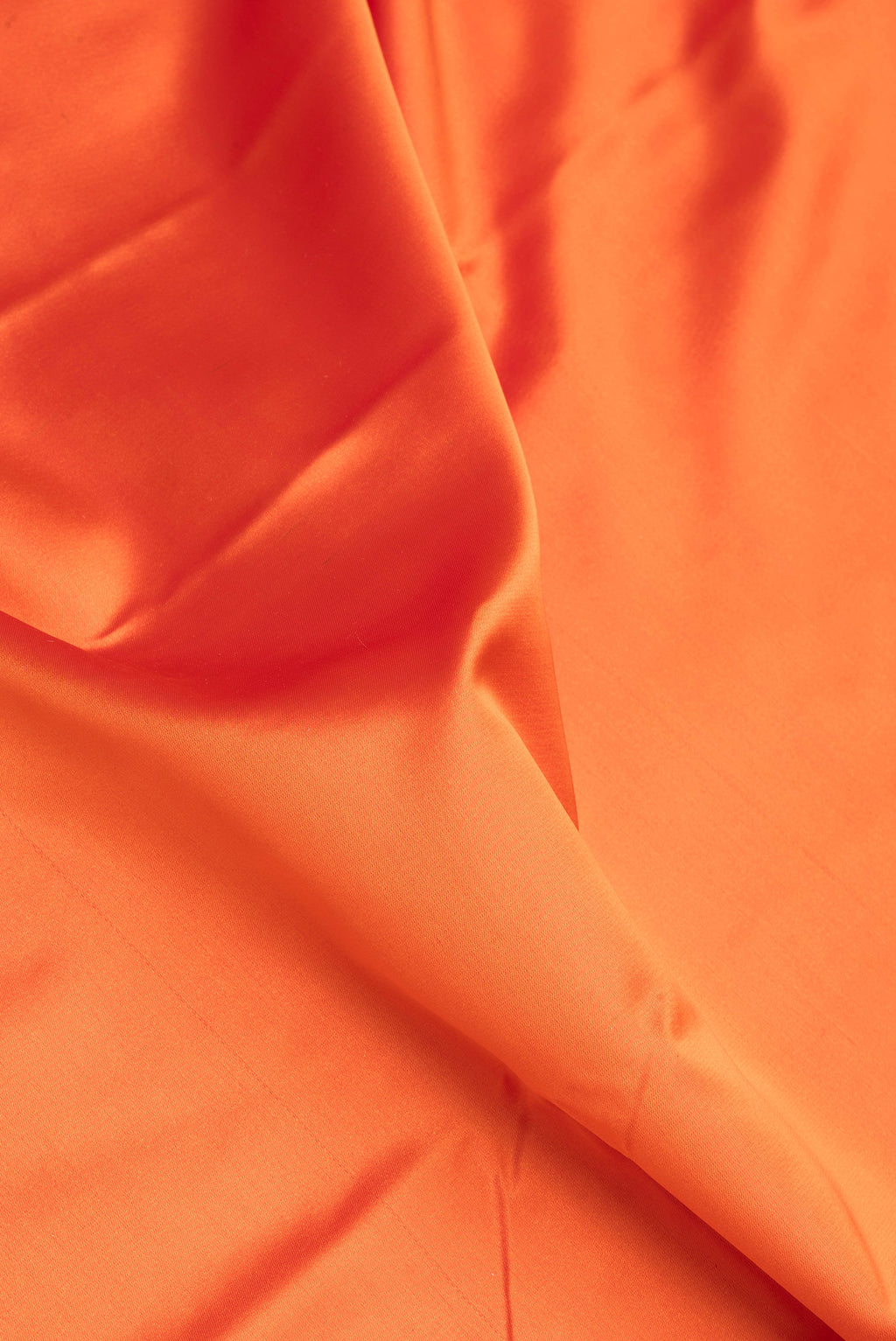 Close up of Orange Blended Banarasi Silk Saree with Plain Body and Zari Border.  displaying folds