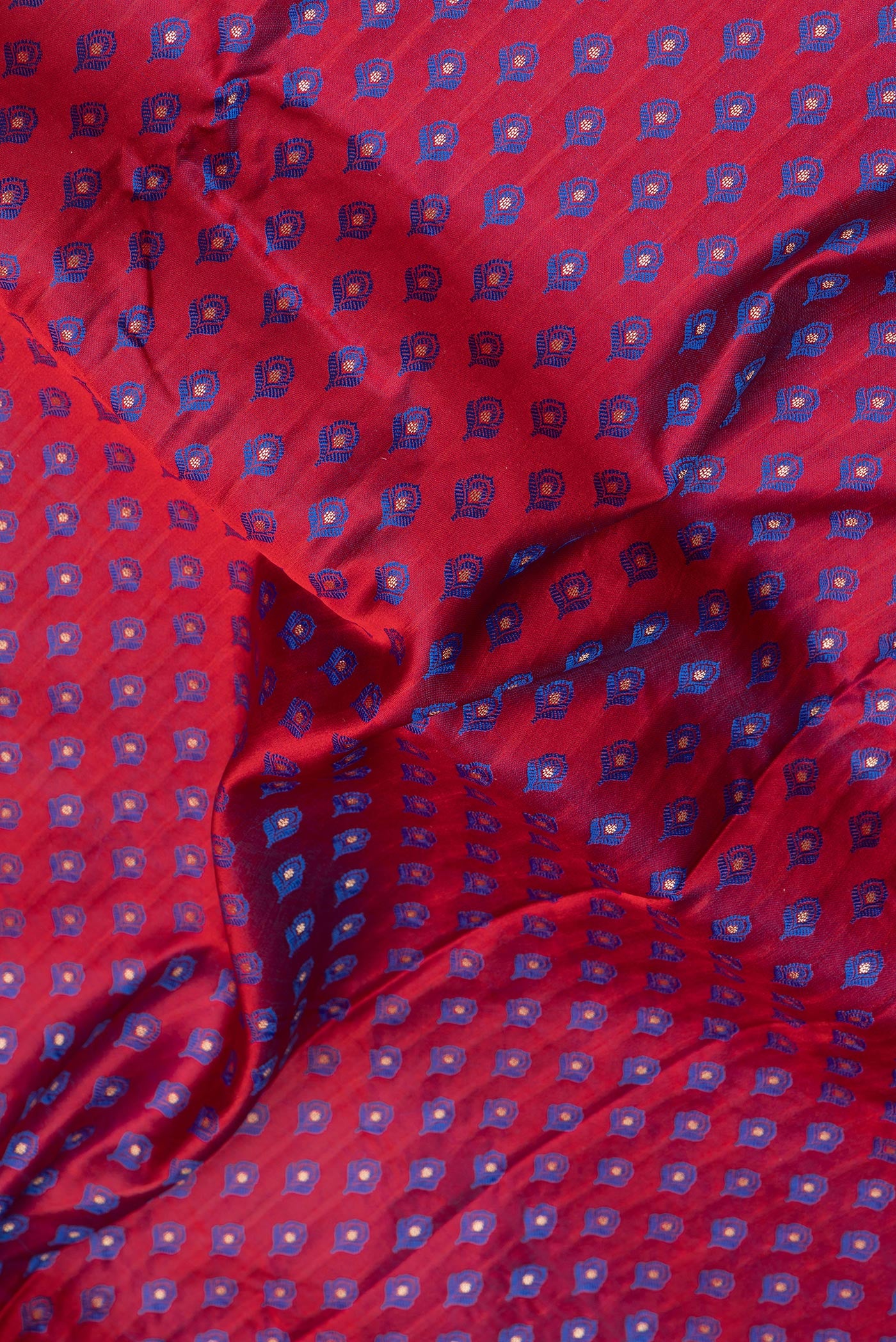 Close up of Maroon Blended Banarasi Silk Saree with Zari And Thread Butta on the body and Zari Border.  displaying folds