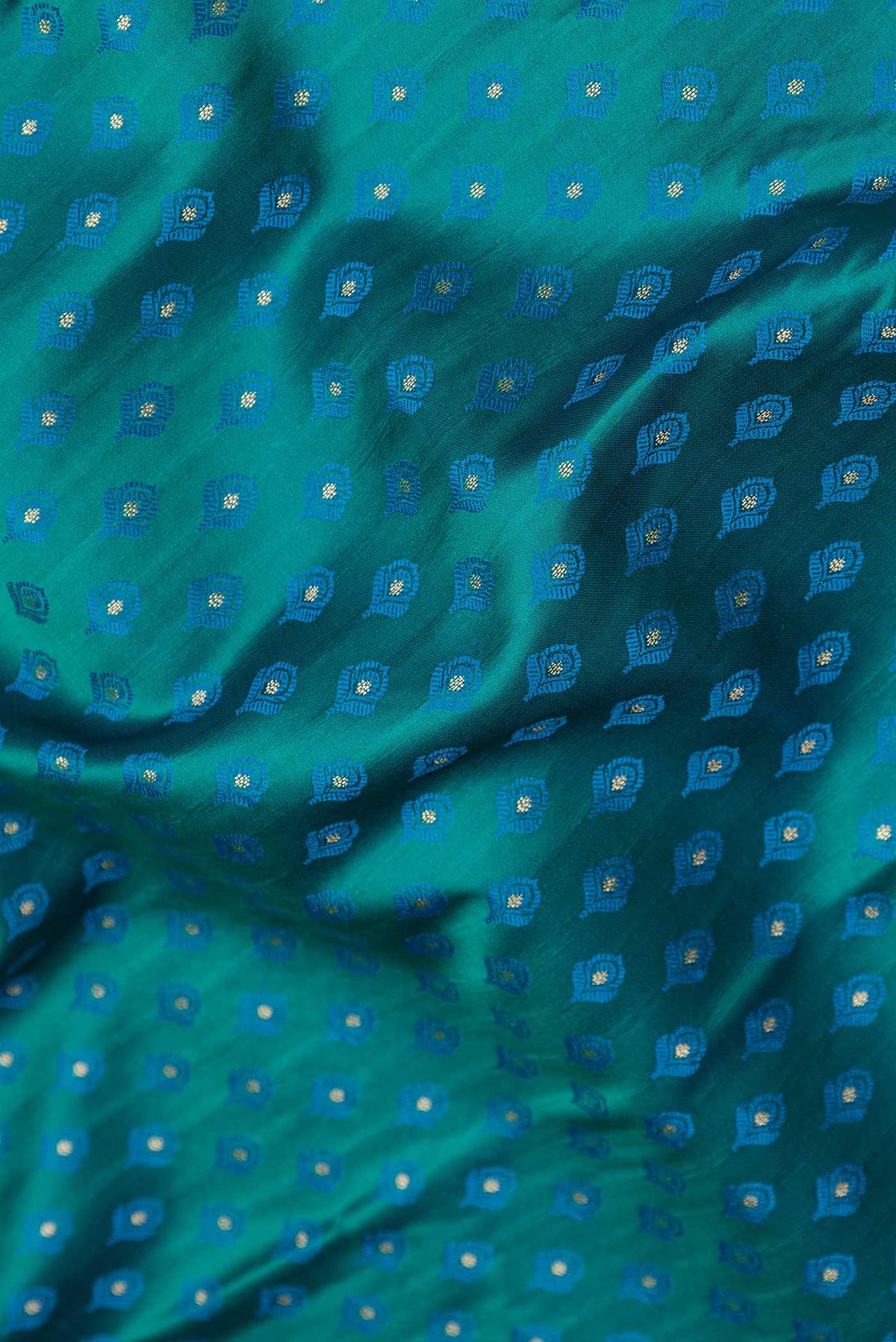 Close up of Peacock Blue Dual Tone Blended Banarasi Saree with Zari And Thread Butta on the body and Zari Border.  displaying folds