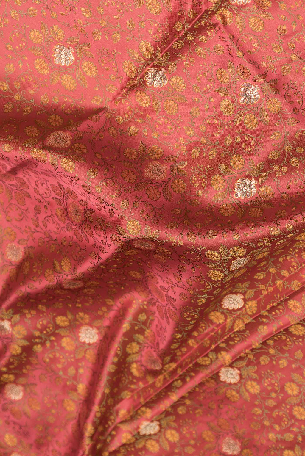 Close up of Peach Dual Tone Blended Banarasi Saree with Jacquard With Zari Butta on the body and Zari Border.  displaying folds