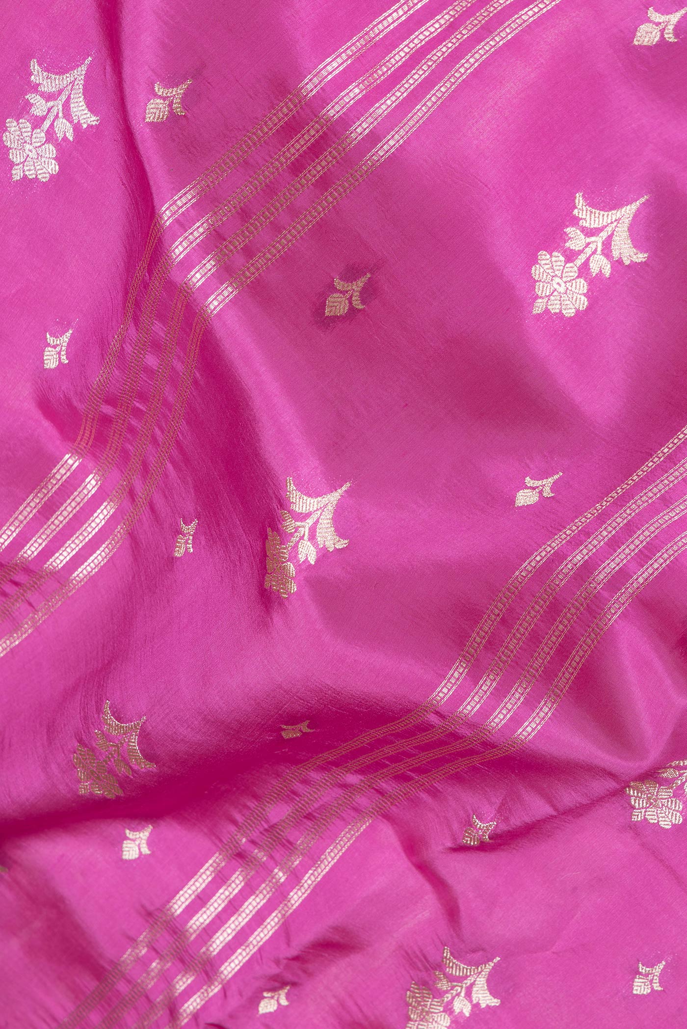Close up of Pink Dual Tone Tussar Silk Saree with Zari Butta on the body and Zari Border.  displaying folds