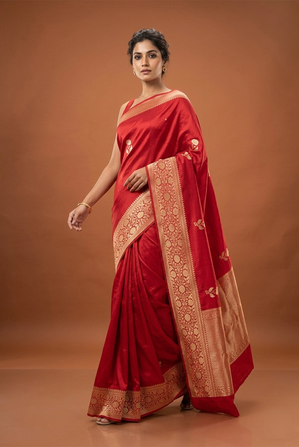 Model wearing a Red Banarasi Katan Silk Saree with Zari Butta on the body and Zari Border.