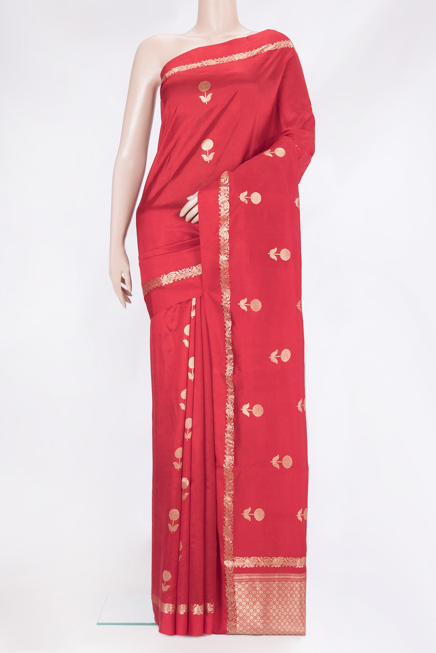 Red Tussar Silk Saree with Zari Butta on the body and Zari Border.  displayed on a mannequin