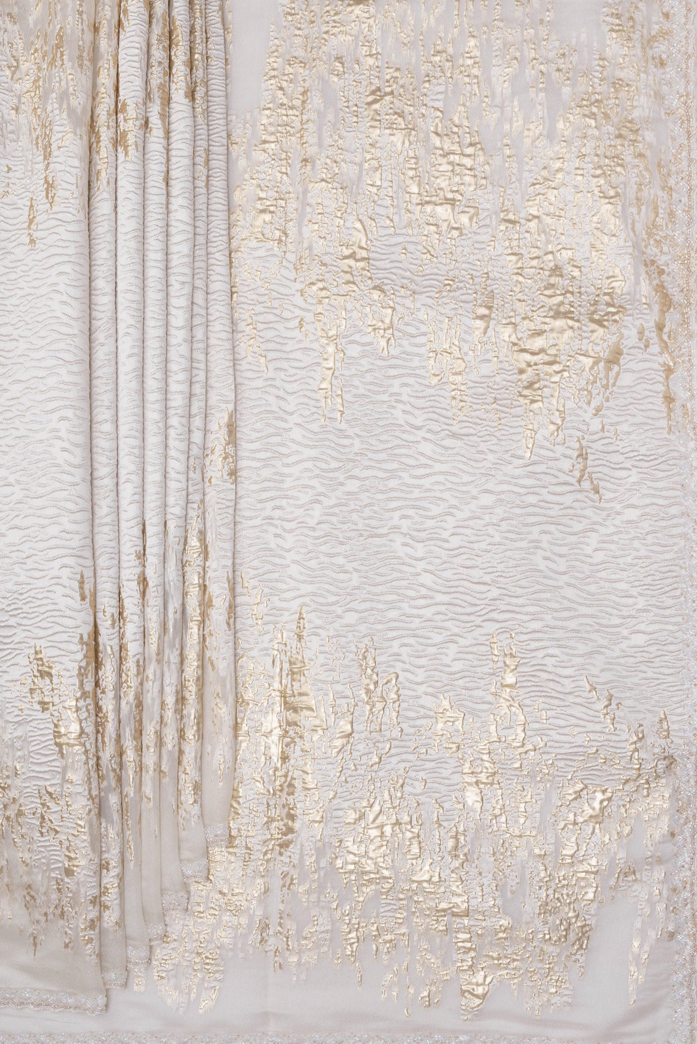 Pleats and pallu of Off White Organza Silk Saree with Zari Brocade on the body and Sequin Border. 