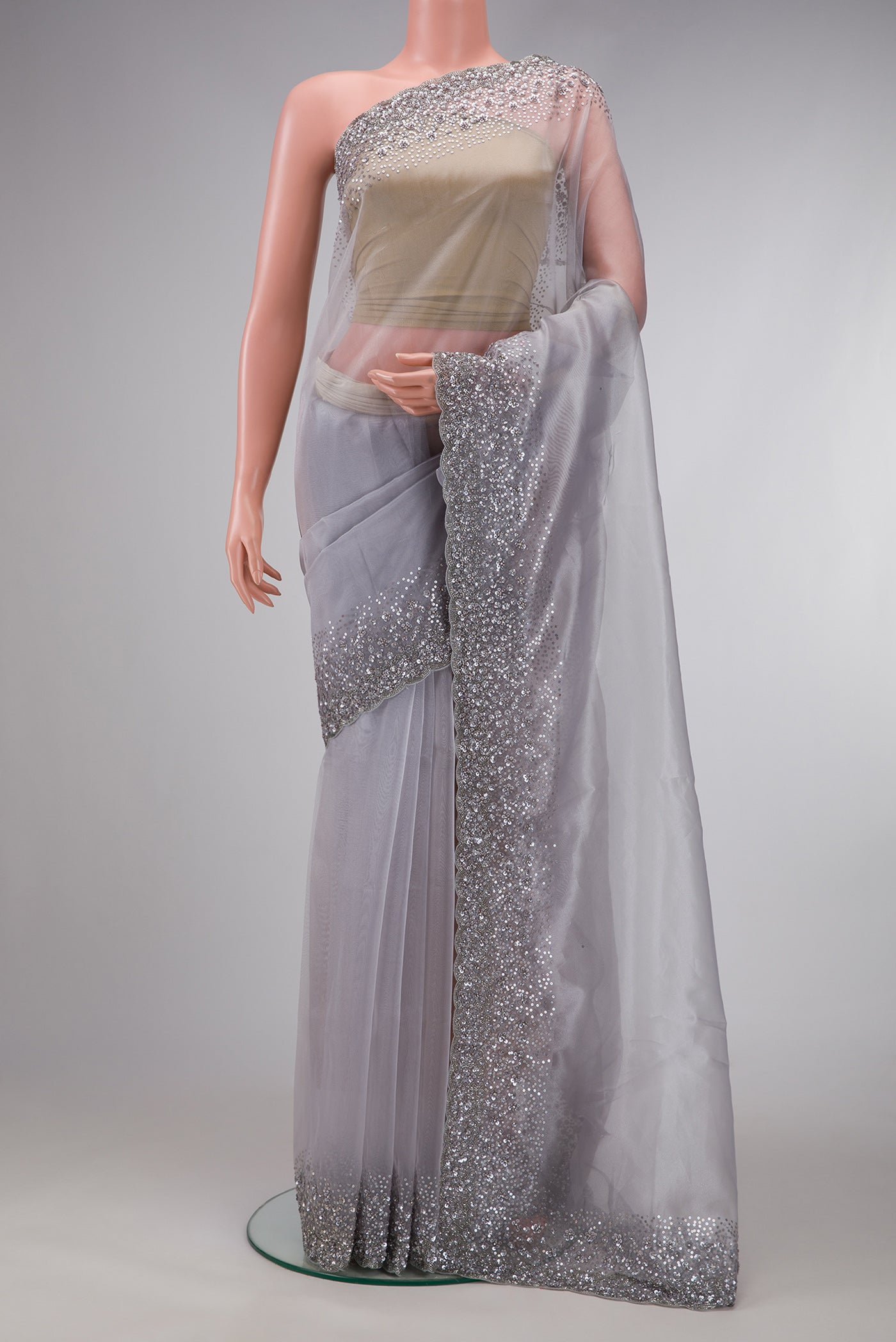 Grey Dual Tone Organza Silk Saree with Plain Body and Embroidery Border.  displayed on a mannequin