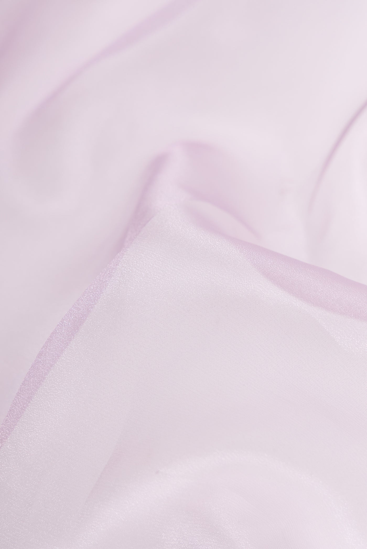 Close up of Lavender Dual Tone Organza Silk Saree with Plain Body and Embroidery Border.  displaying folds