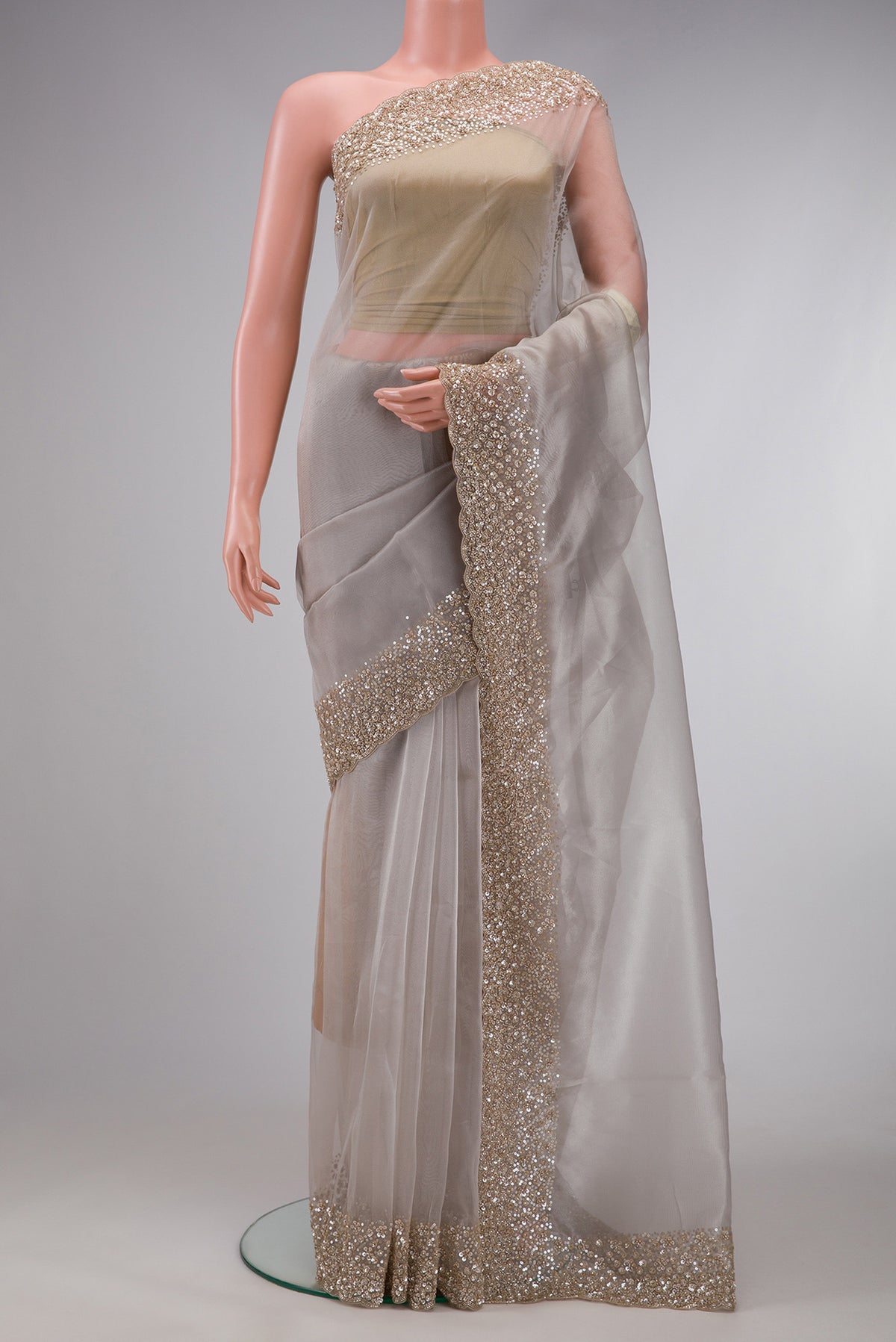 Beige Dual Tone Organza Silk Saree with Plain Body and Embroidery Border.  displayed on a mannequin