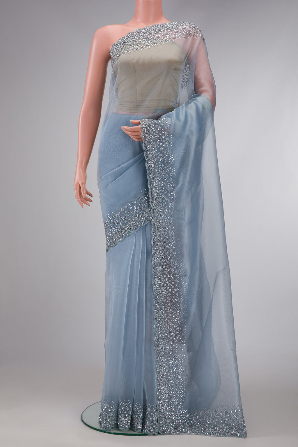 Sky Blue Dual Tone Organza Silk Saree with Plain Body and Embroidery Border.  displayed on a mannequin