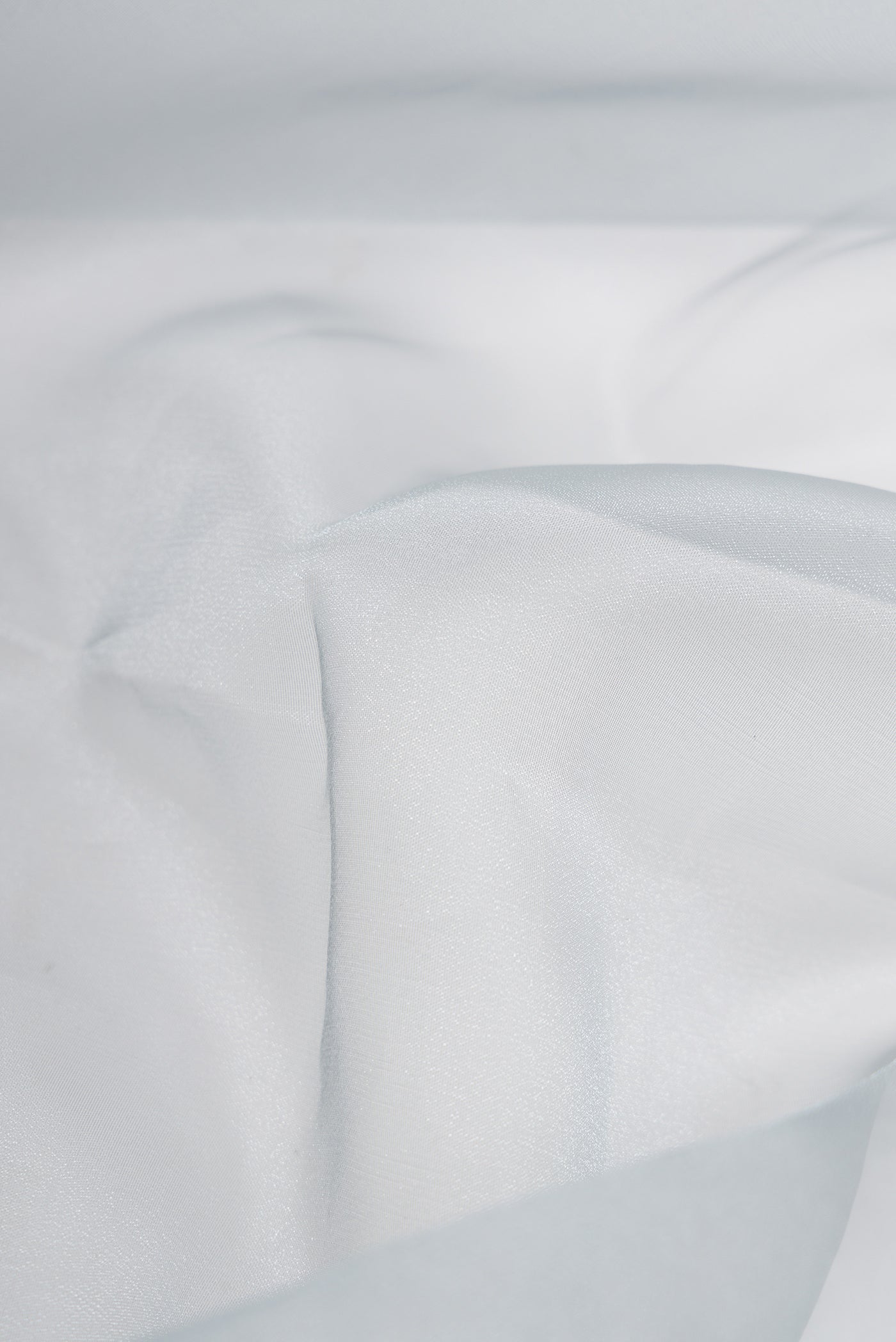 Close up of Grey Dual Tone Organza Silk Saree with Plain Body and Embroidery Border.  displaying folds