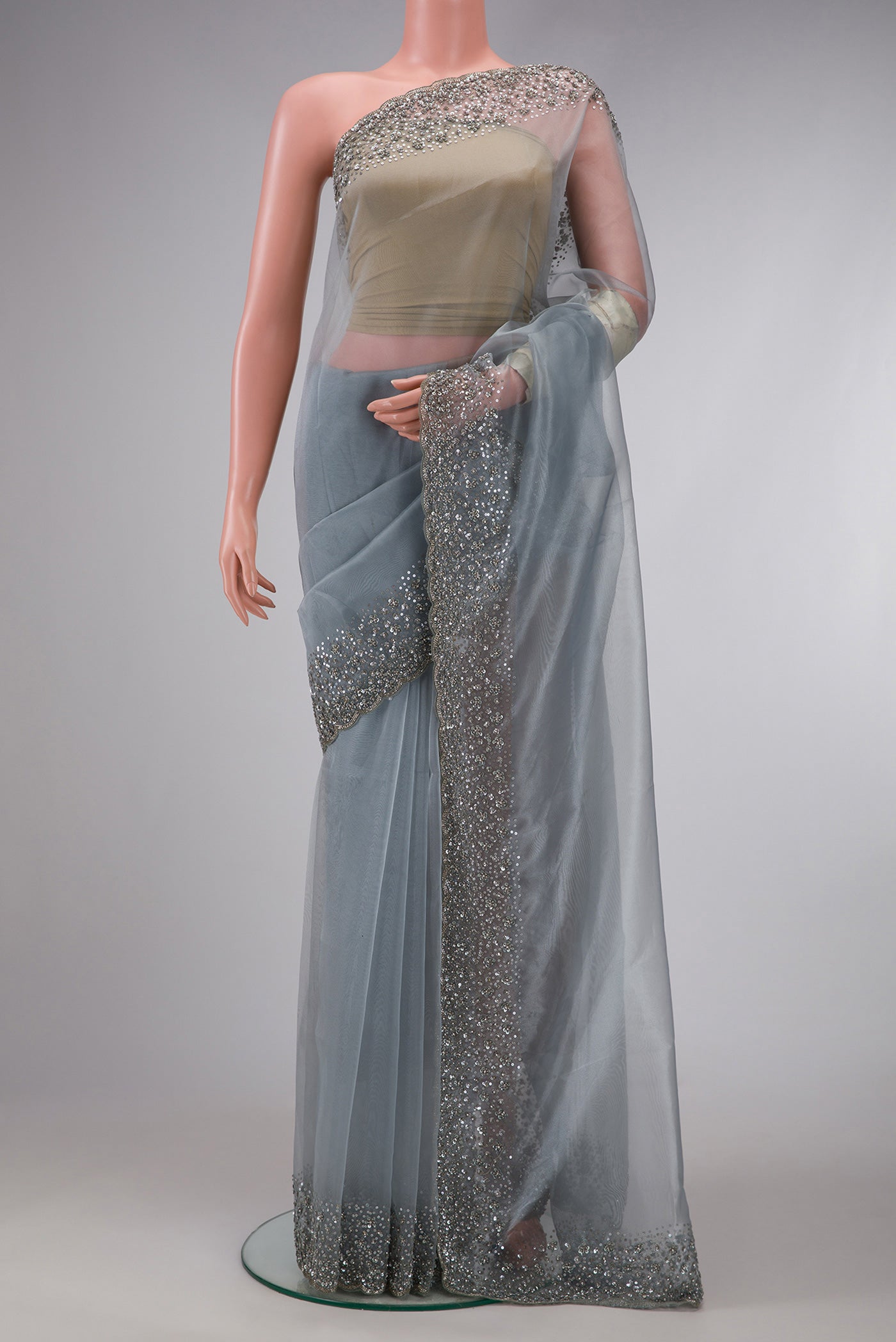 Grey Dual Tone Organza Silk Saree with Plain Body and Embroidery Border.  displayed on a mannequin