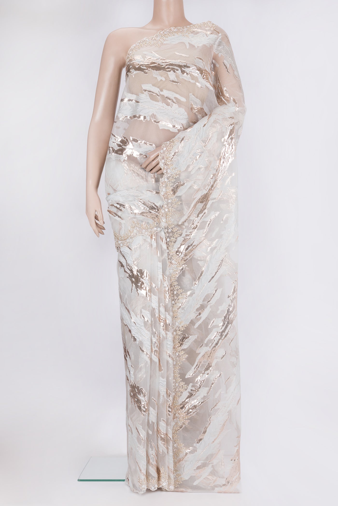 Off White Organza Silk Saree with Zari Brocade on the body and Sequin Border.  displayed on a mannequin