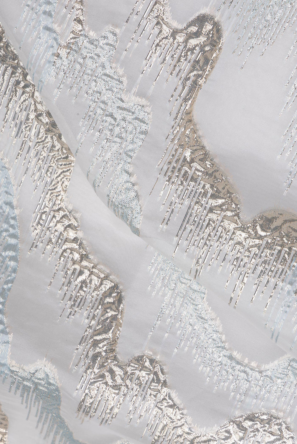 Close up of Light Blue Organza Silk Saree with Zari Brocade on the body and Sequin Border.  displaying folds