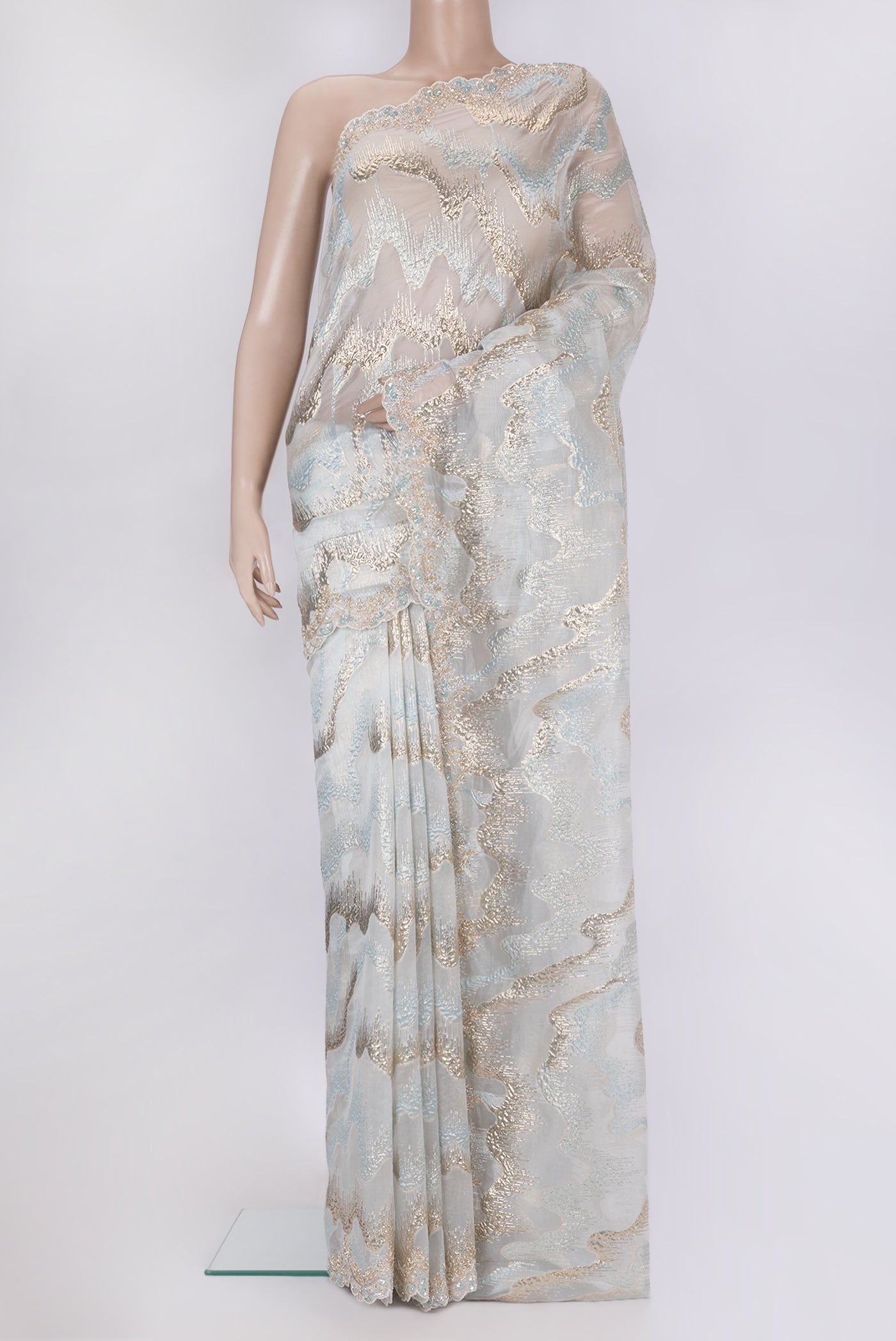 Light Blue Organza Silk Saree with Zari Brocade on the body and Sequin Border.  displayed on a mannequin