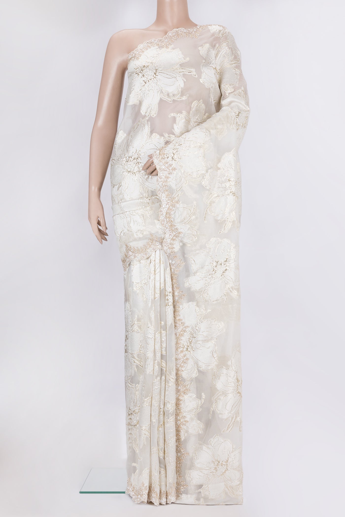Off White Organza Silk Saree with Zari Brocade on the body and Embroidery Border.  displayed on a mannequin