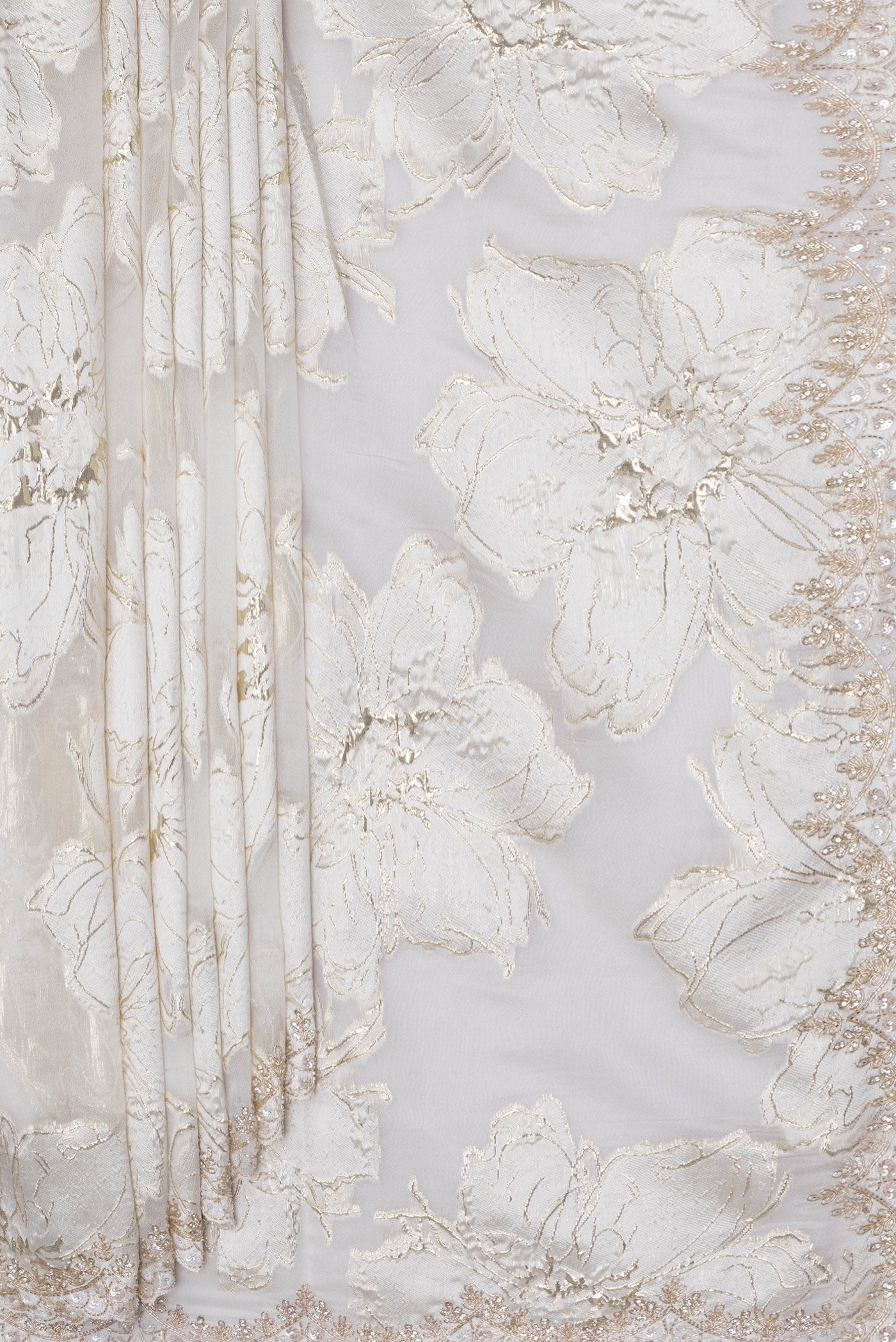 Pleats and pallu of Off White Organza Silk Saree with Zari Brocade on the body and Embroidery Border. 