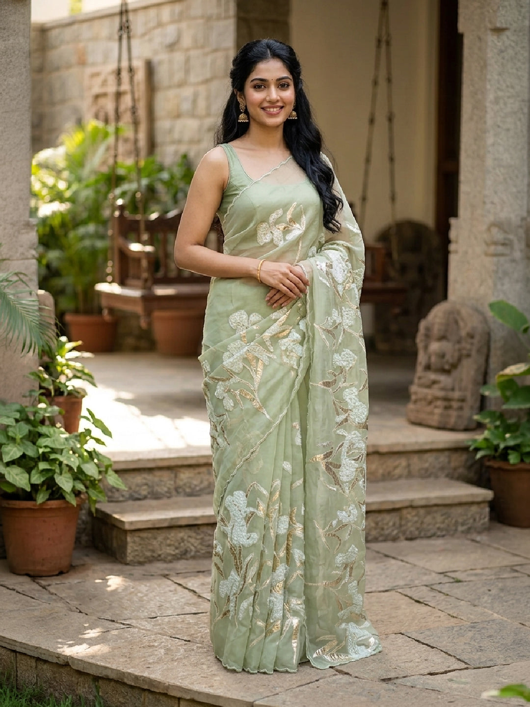 Model wearing a Light Green Organza Silk Saree with Embroidery on the body and Embroidery Border.