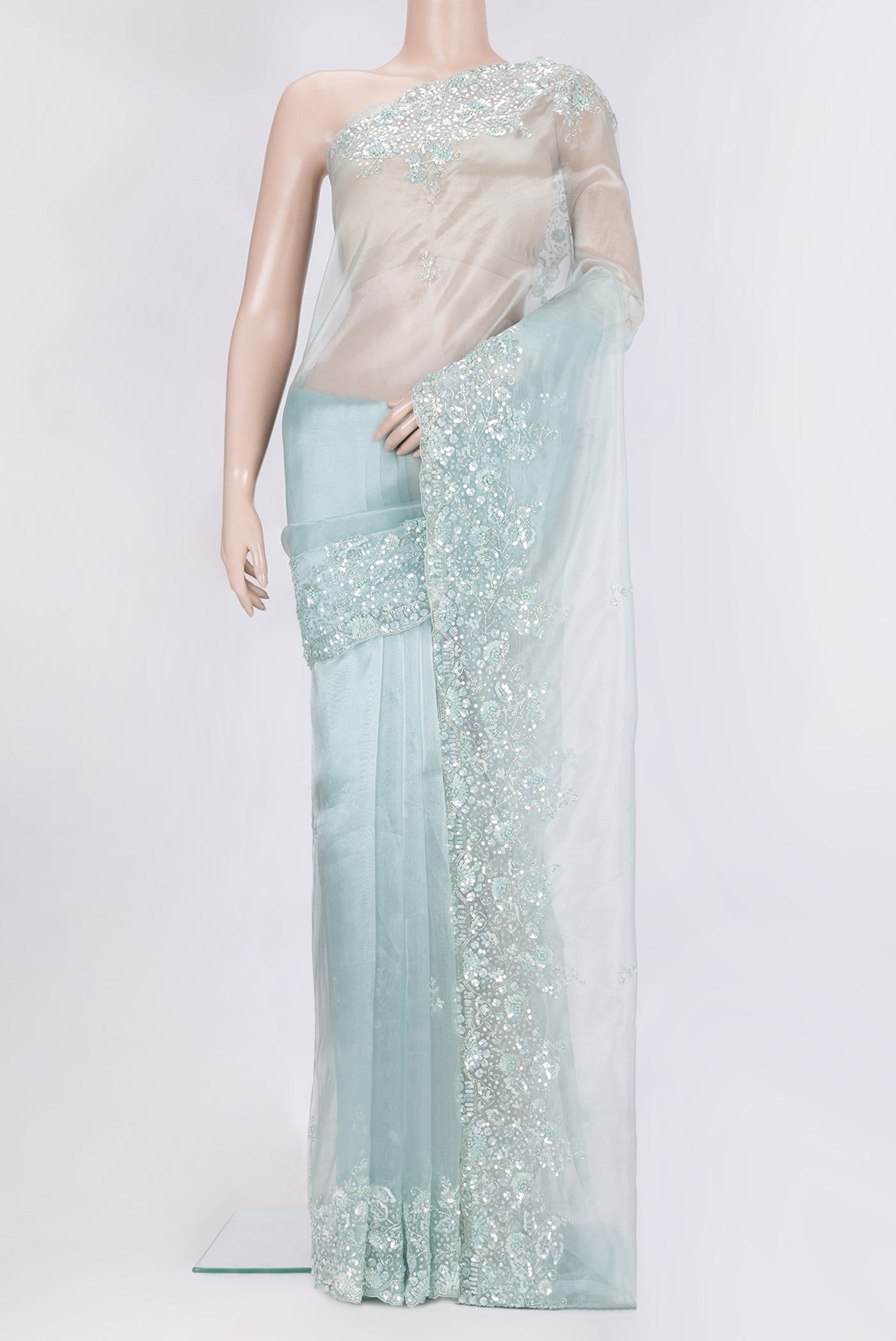 Pure Silk Light Blue Organza Saree with Embroidery on the body and Embroidery Border.  displayed on a mannequin