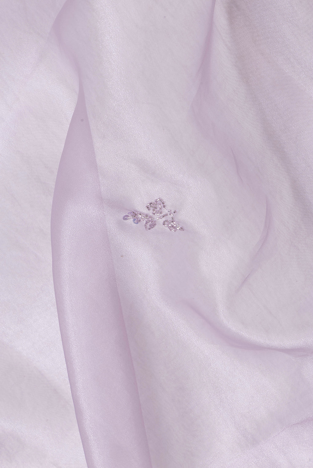 Close up of Lavender Dual Tone Organza Silk Saree with Embroidery on the body and Embroidery Border.  displaying folds