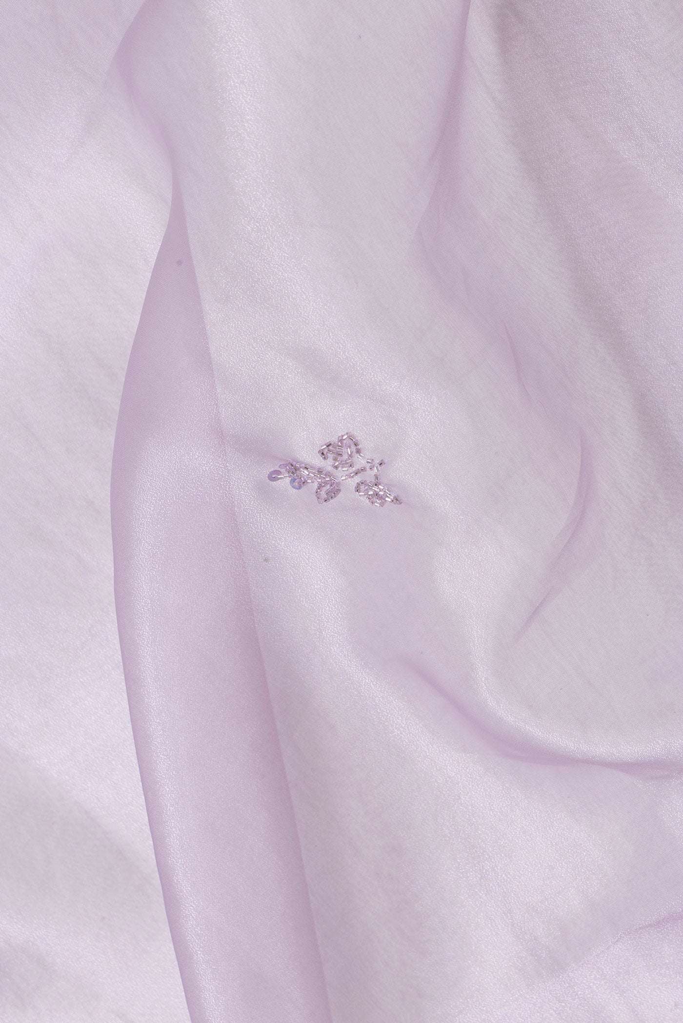 Close up of Lavender Dual Tone Organza Silk Saree with Embroidery on the body and Embroidery Border.  displaying folds