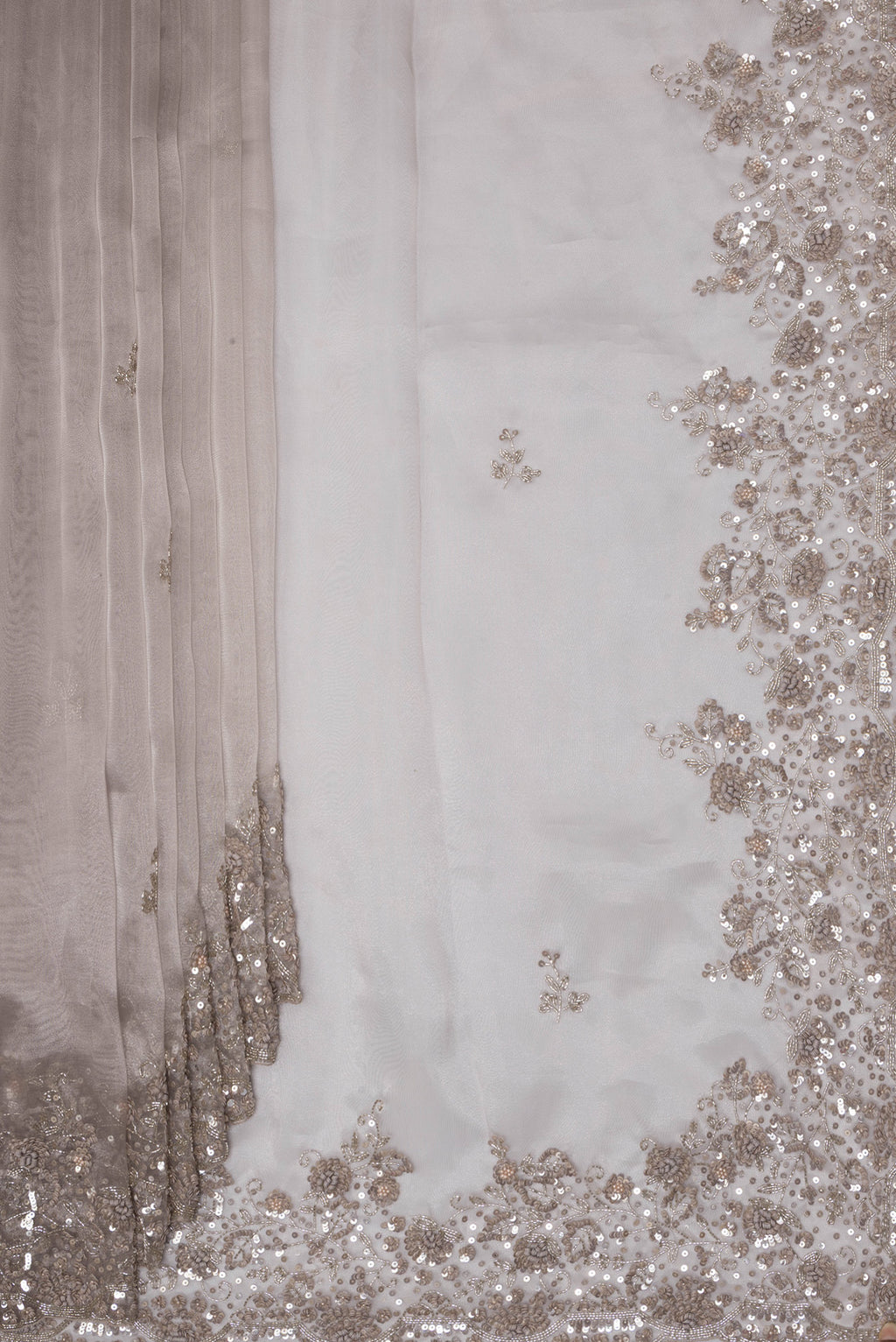 Pleats and pallu of Lilac Dual Tone Organza Saree with Embroidery on the body and Embroidery Border. 