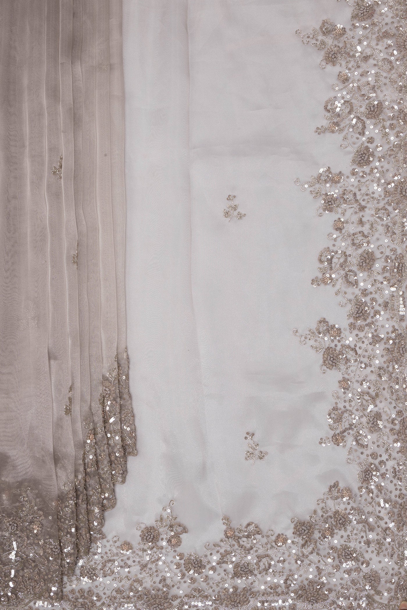 Pleats and pallu of Lilac Dual Tone Organza Saree with Embroidery on the body and Embroidery Border. 