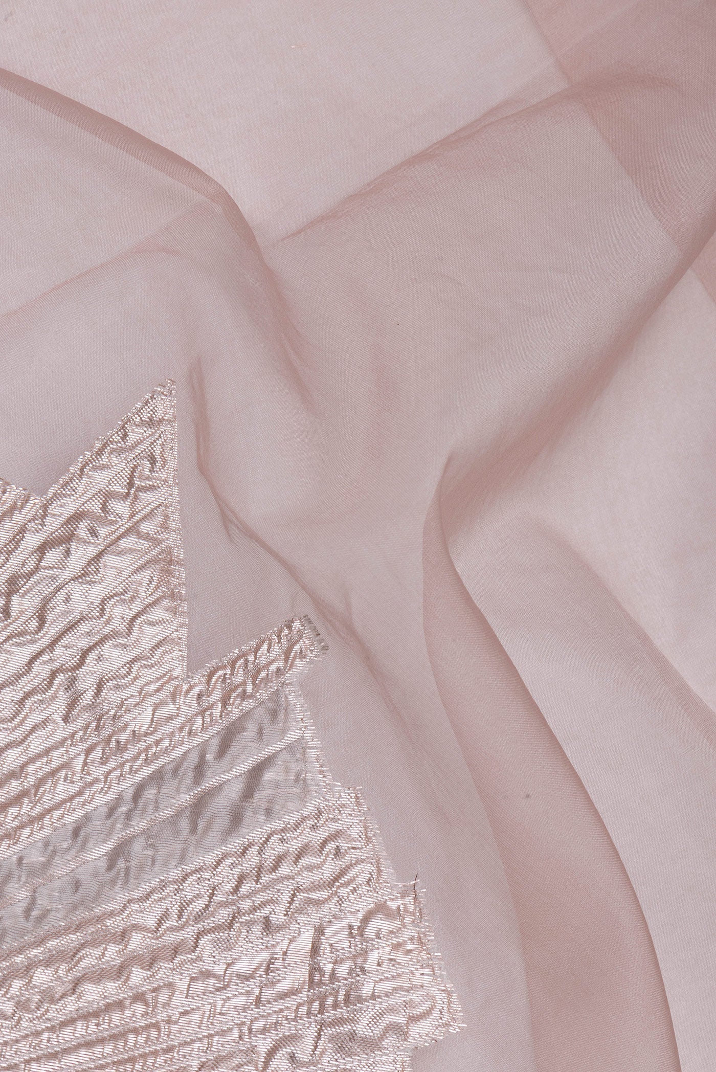 Close up of Rose Gold Organza Silk Saree with Zari Brocade on the body and Embroidery Border.  displaying folds
