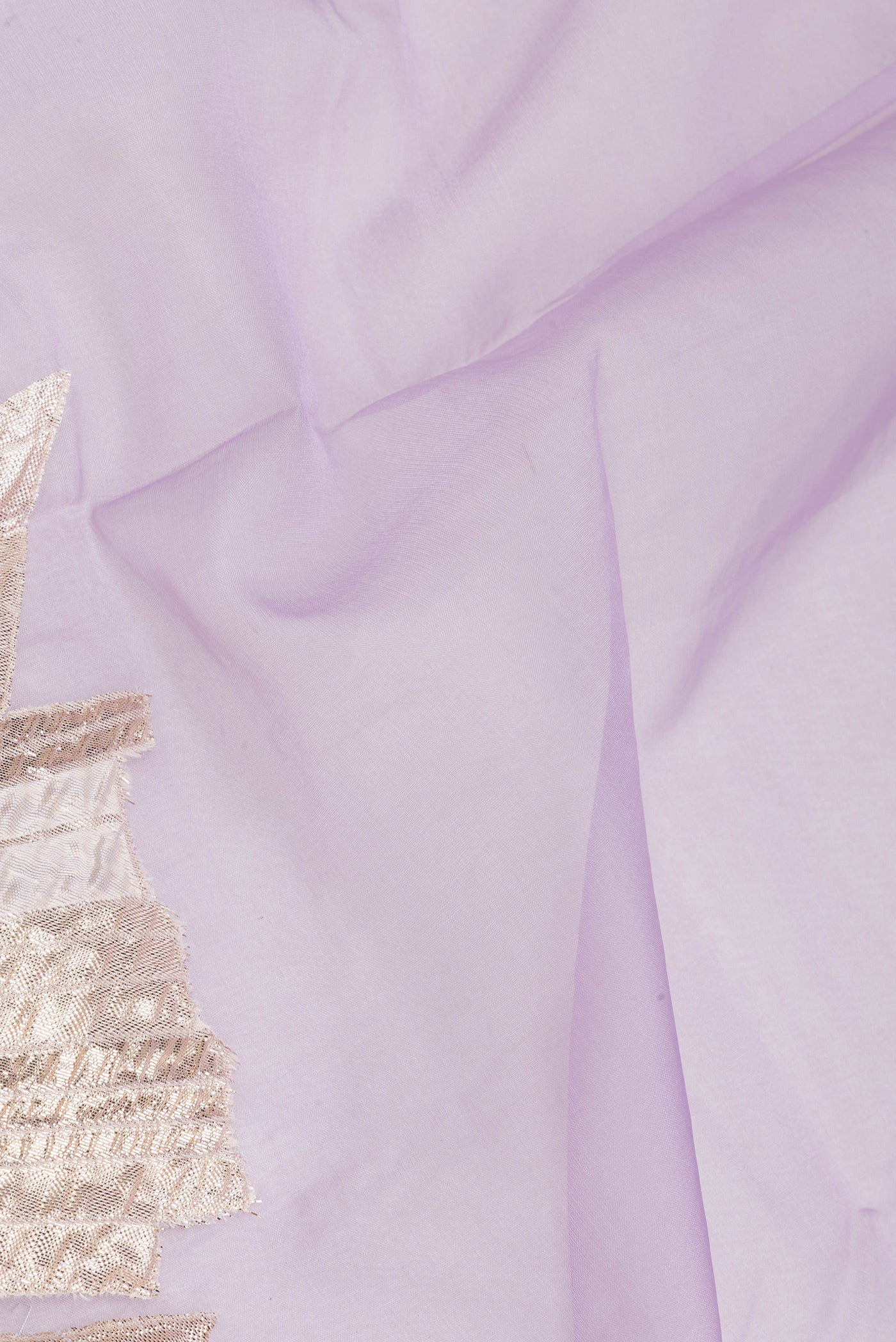 Close up of Lavender Organza Silk Saree with Zari Brocade on the body and Embroidery Border.  displaying folds