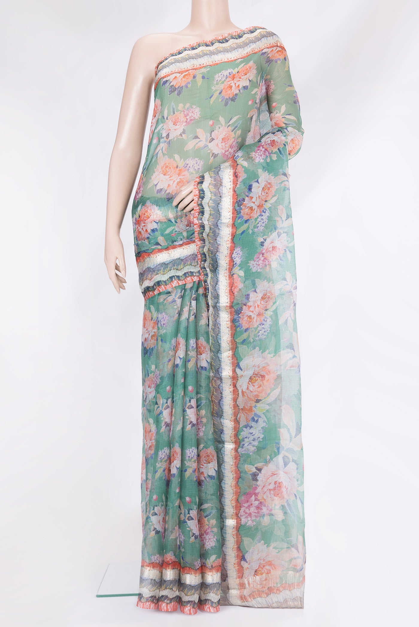 Green Kota Silk Saree with Printed design on the body and Fancy Border.  displayed on a mannequin