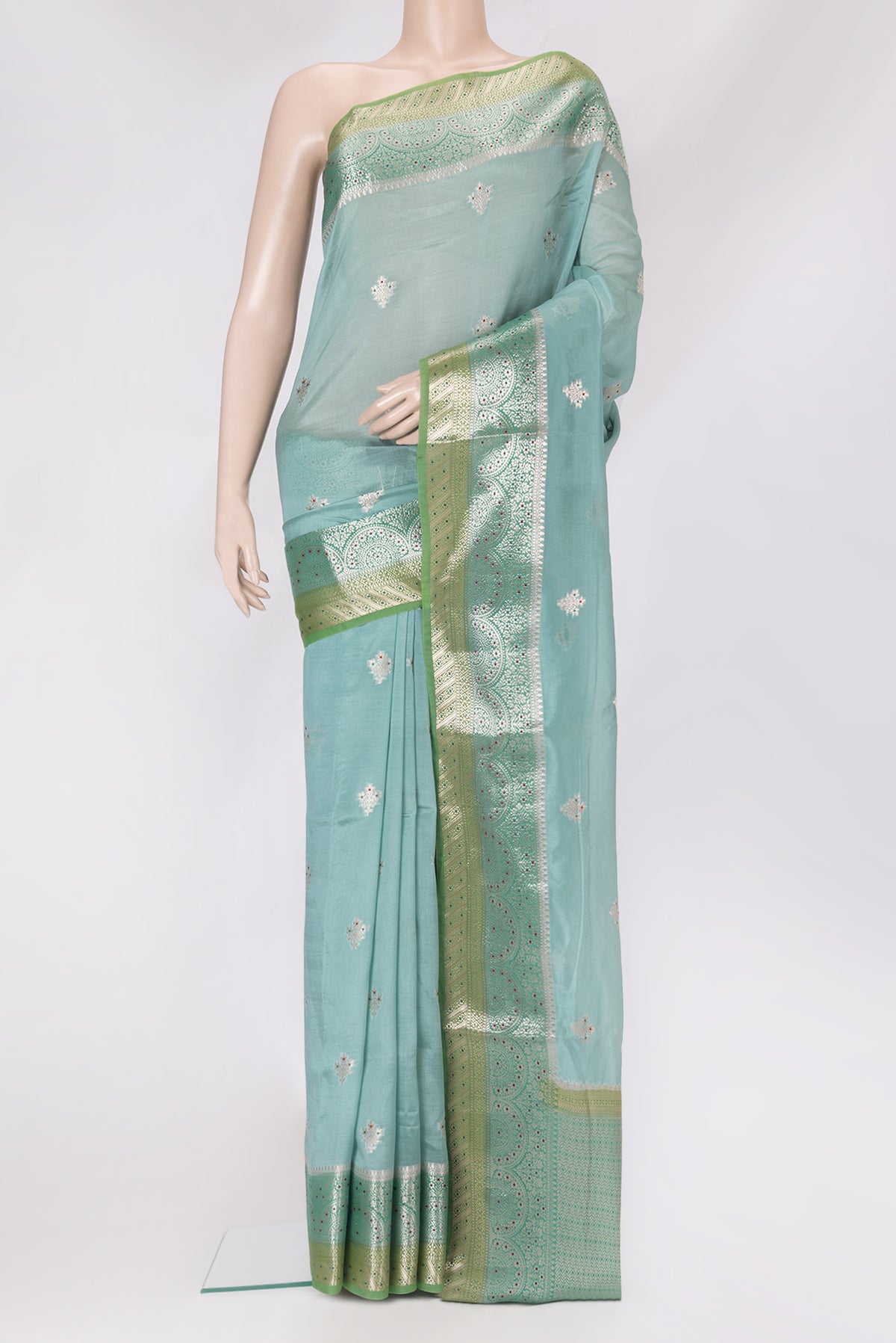 Light Blue Blended Tussar Silk Saree with Zari Butta on the body and Fancy Border.  displayed on a mannequin