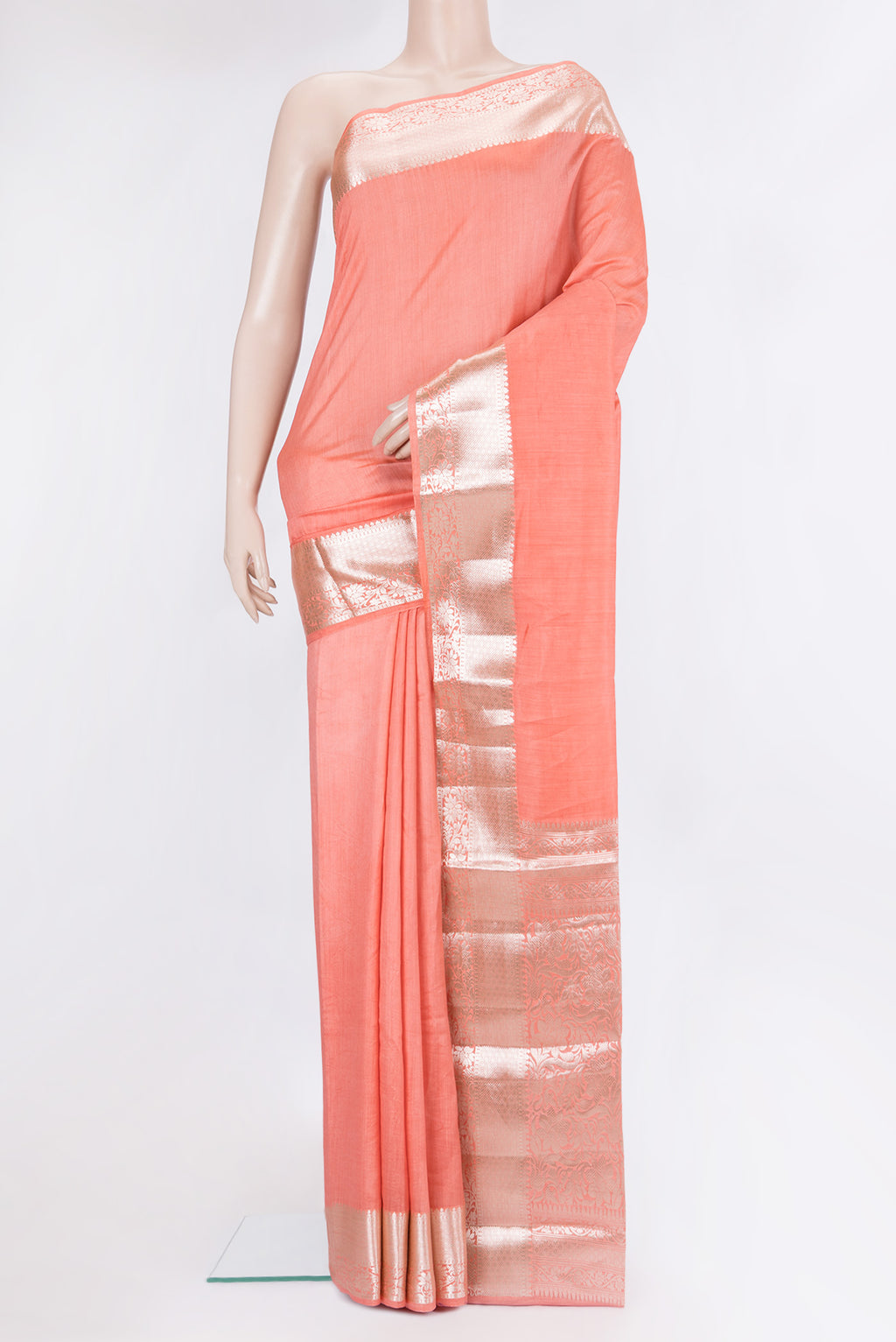 Peach Tussar Silk Saree with Plain Body and Fancy Border.  displayed on a mannequin