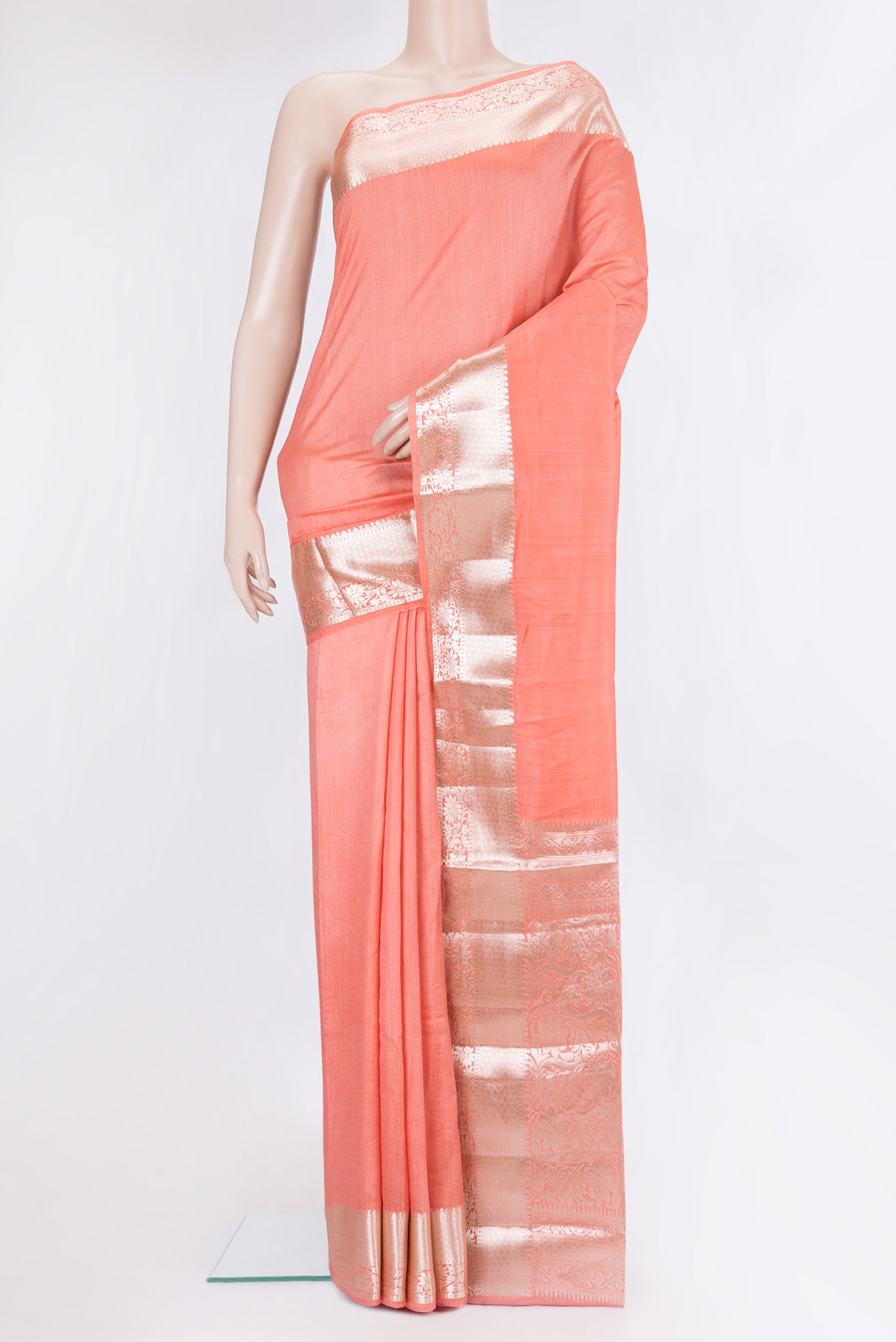 Peach Tussar Silk Saree with Plain Body and Fancy Border.  displayed on a mannequin