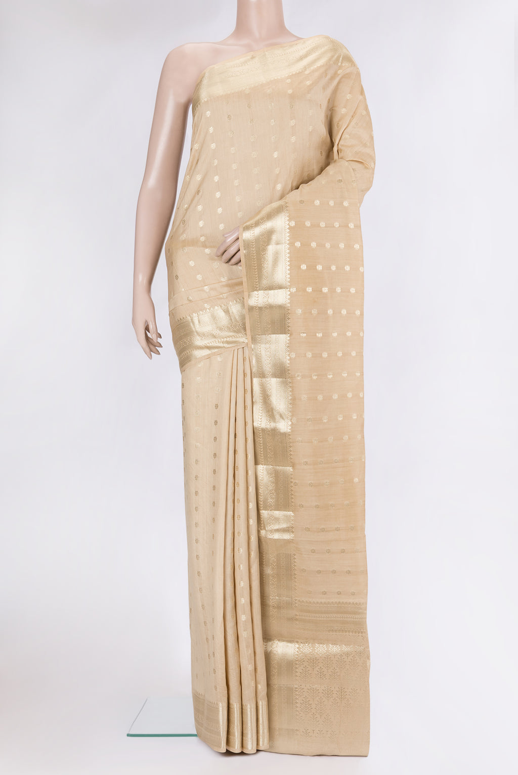 Beige Tussar Silk Saree with Zari Butta on the body and Zari Border.  displayed on a mannequin