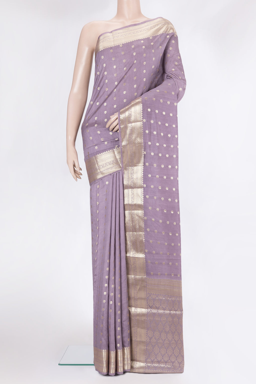 Lilac Tussar Silk Saree with Zari Butta on the body and Zari Border.  displayed on a mannequin