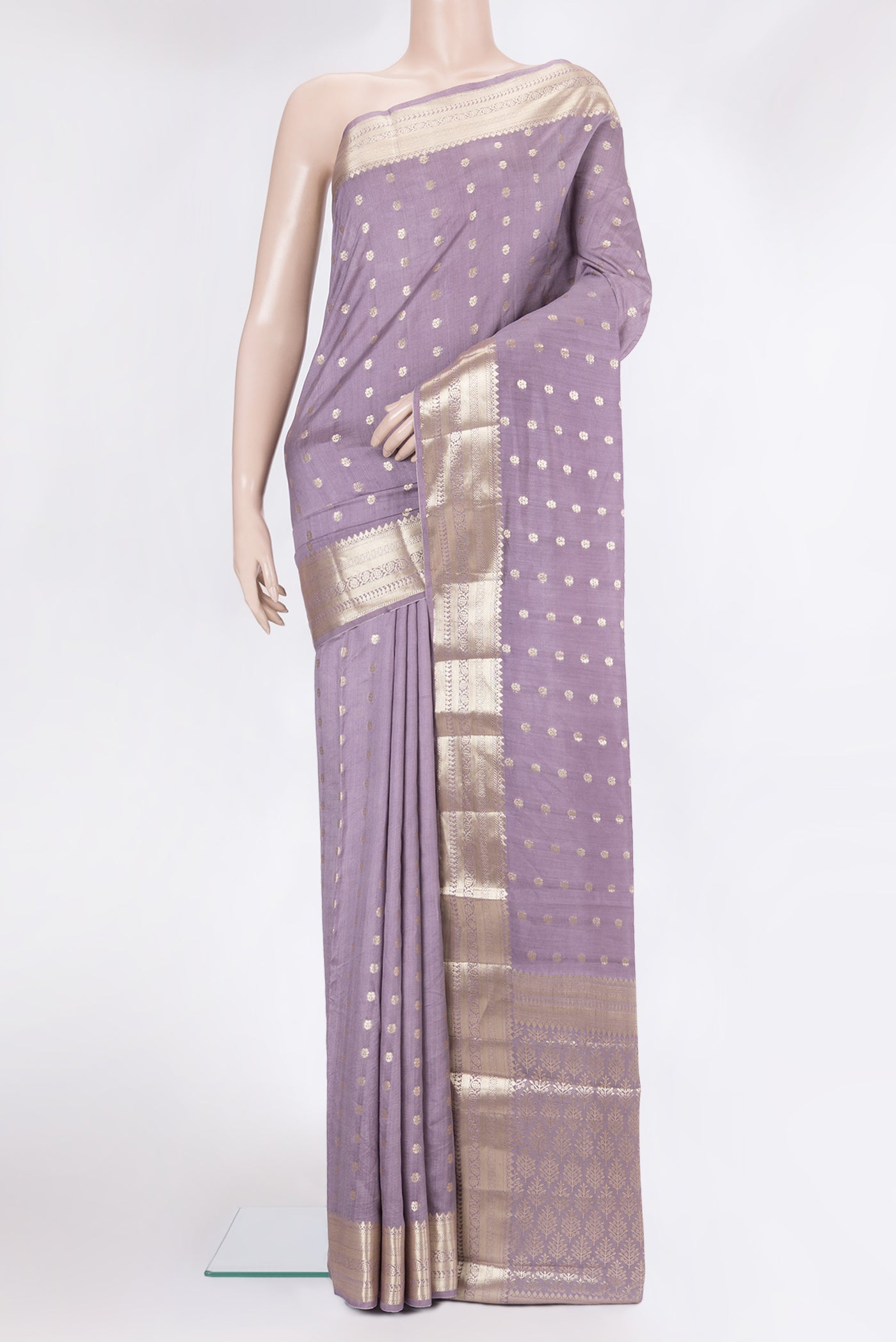 Lilac Tussar Silk Saree with Zari Butta on the body and Zari Border.  displayed on a mannequin