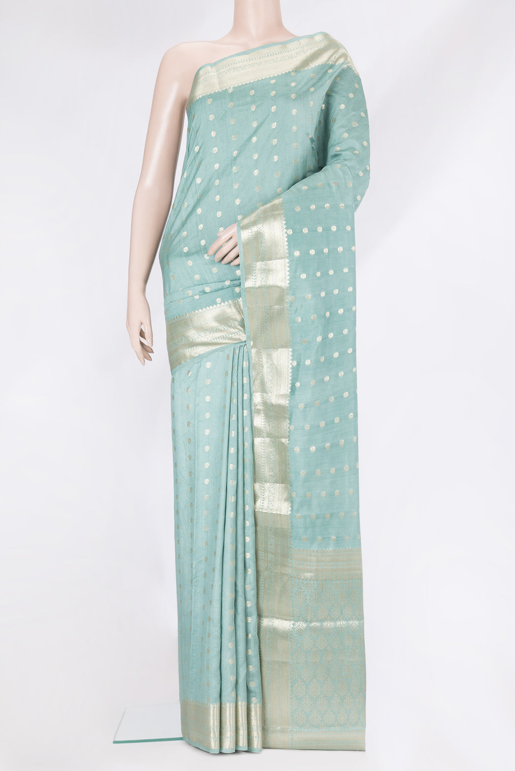 Light Blue Tussar Silk Saree with Zari Butta on the body and Zari Border.  displayed on a mannequin