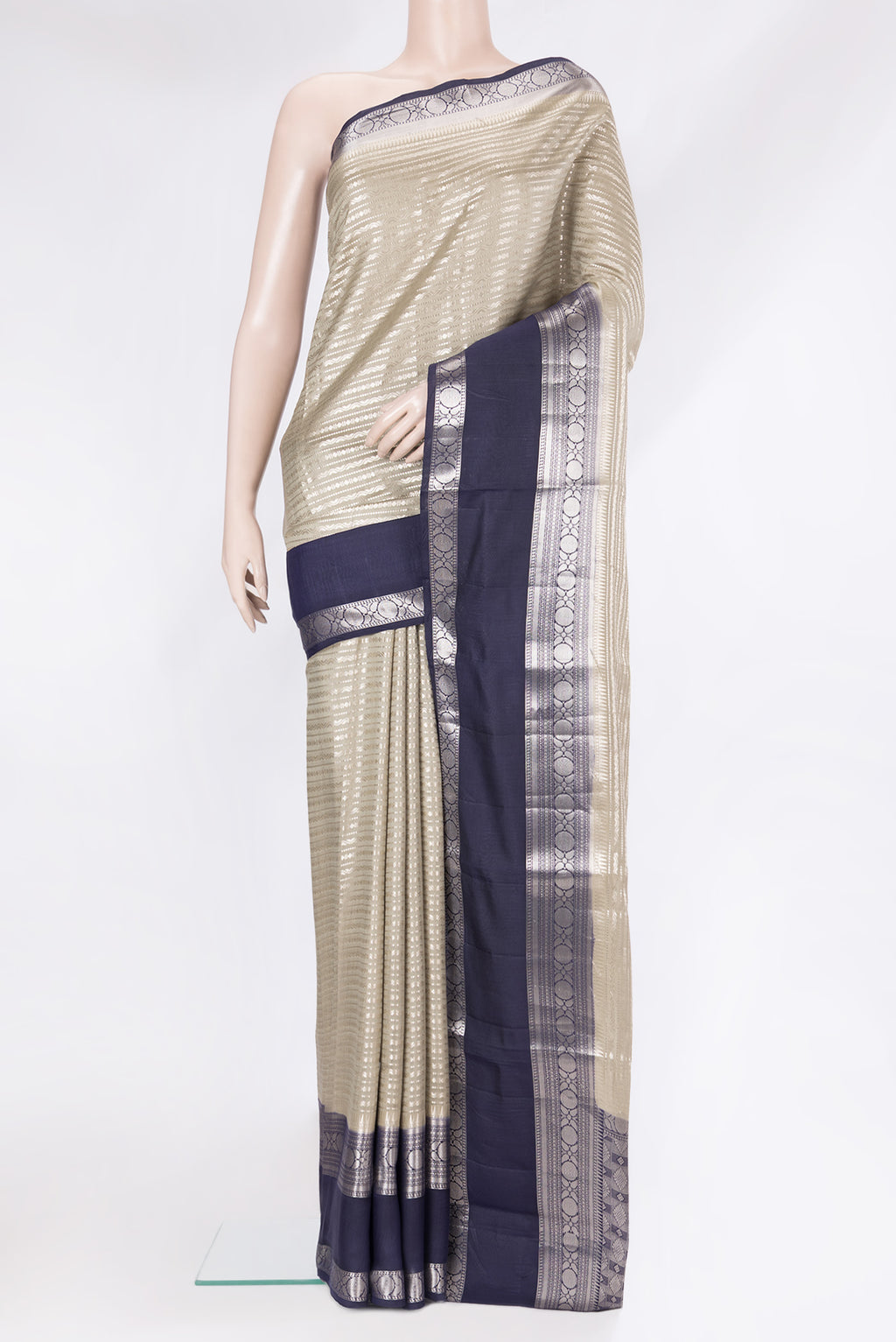 Beige Tussar Silk Saree with Zari Brocade on the body and Zari Border.  displayed on a mannequin