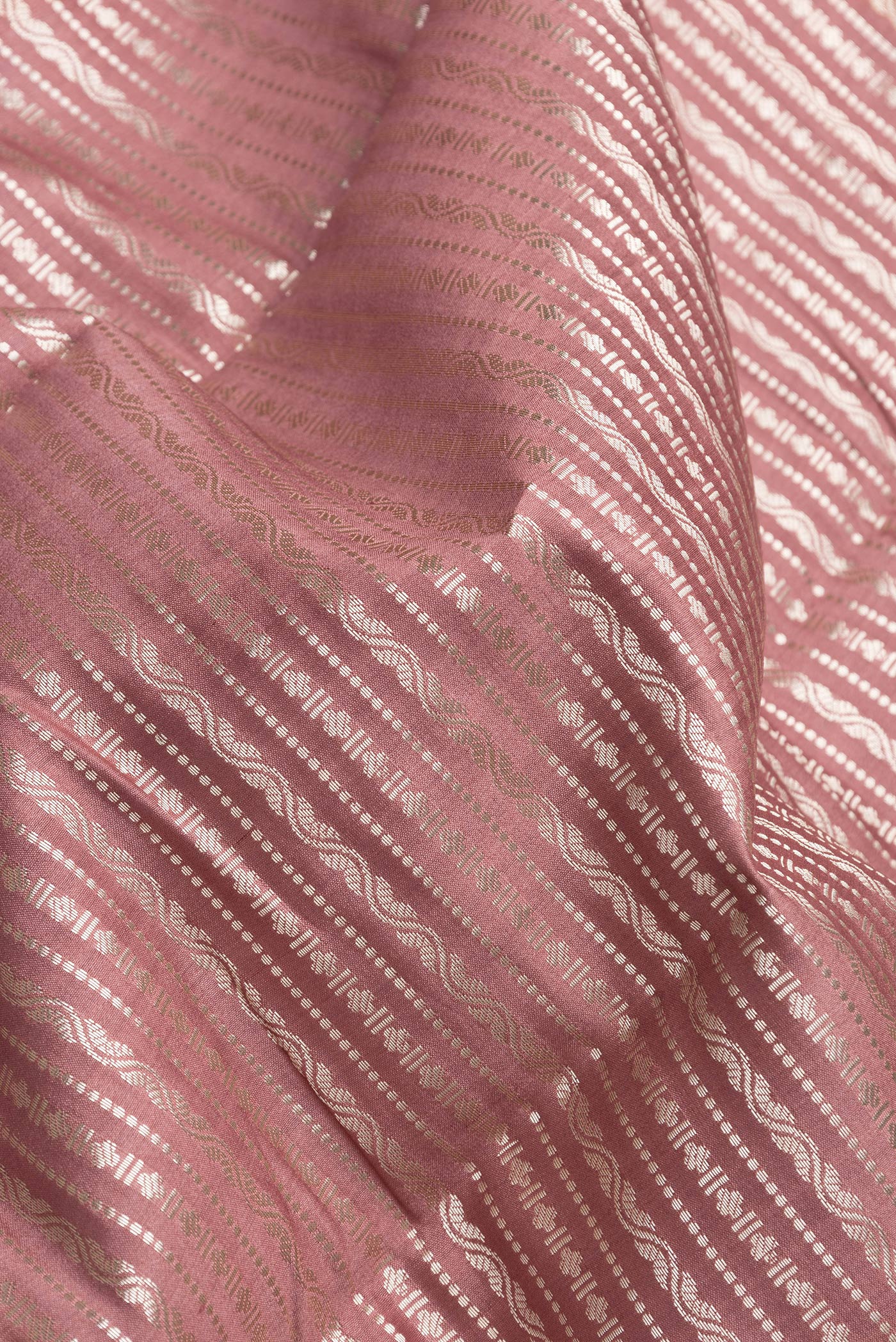 Close up of Brown Dual Tone Tussar Silk Saree with Zari Brocade on the body and Zari Border.  displaying folds