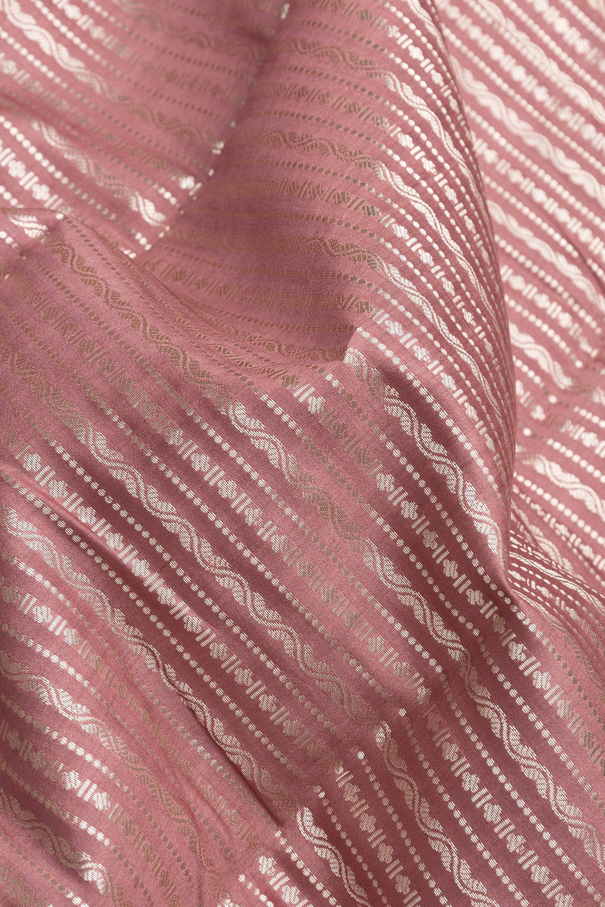 Close up of Brown Dual Tone Tussar Silk Saree with Zari Brocade on the body and Zari Border.  displaying folds